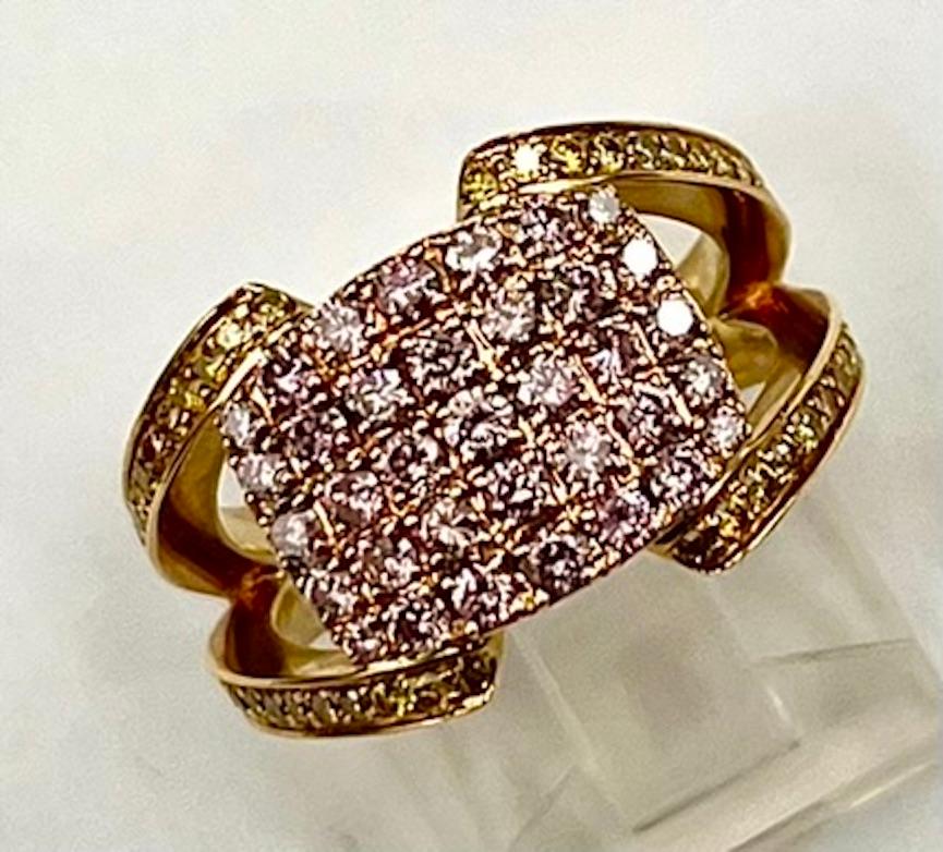 This is a beautiful and very easily worn band composed of .84Ct Total Weight of natural intense pink diamonds as well as .58Ct Total Weight of natural intense yellow diamonds.  For a time when a large gemstone or diamond isn't called for or