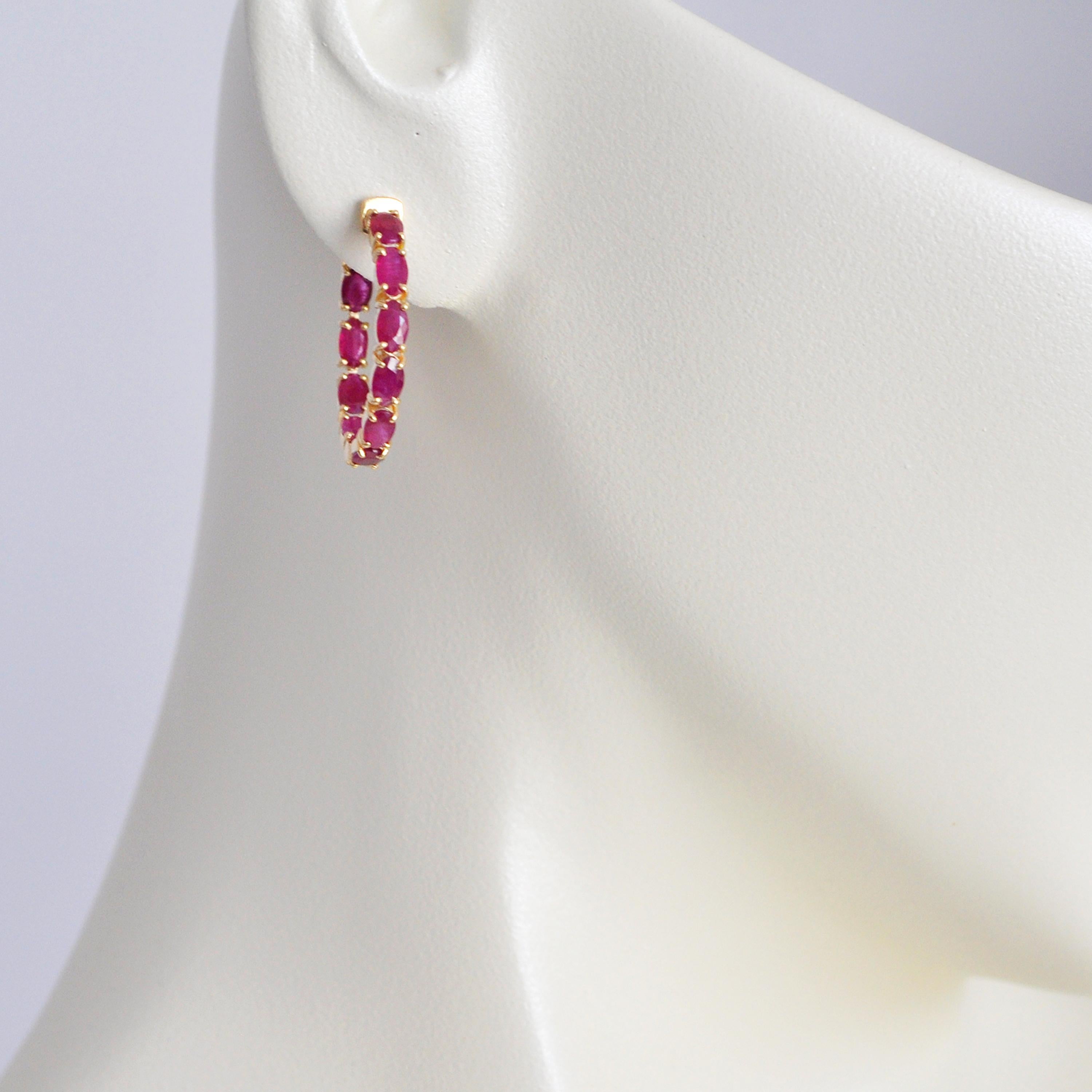 Elevate your elegance with our 18K Gold Mozambique Ruby 5x3 Oval Classic Hoop Earrings with an easy to use lock system. A true embodiment of luxury and grace, these earrings showcase the mesmerizing allure of Mozambique rubies in a uniquely timeless