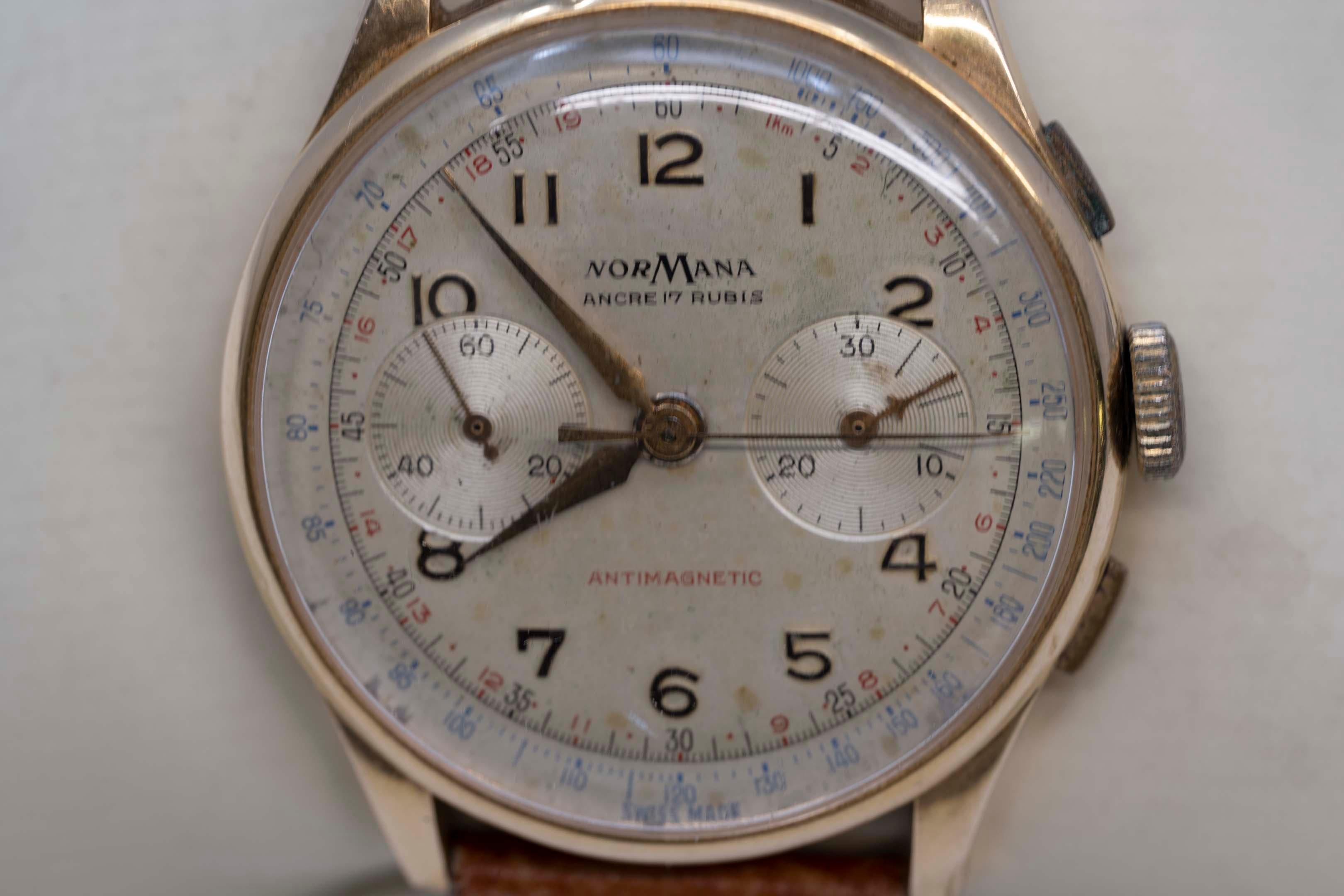 One vintage wristwatch for men marked NorMana. 18k (750, stamped), mechanical movement, chronometer. Tissot brown colored bracelet. Weighs 49.1 grams. 38mm case without the crown. Crown is not the original. 
