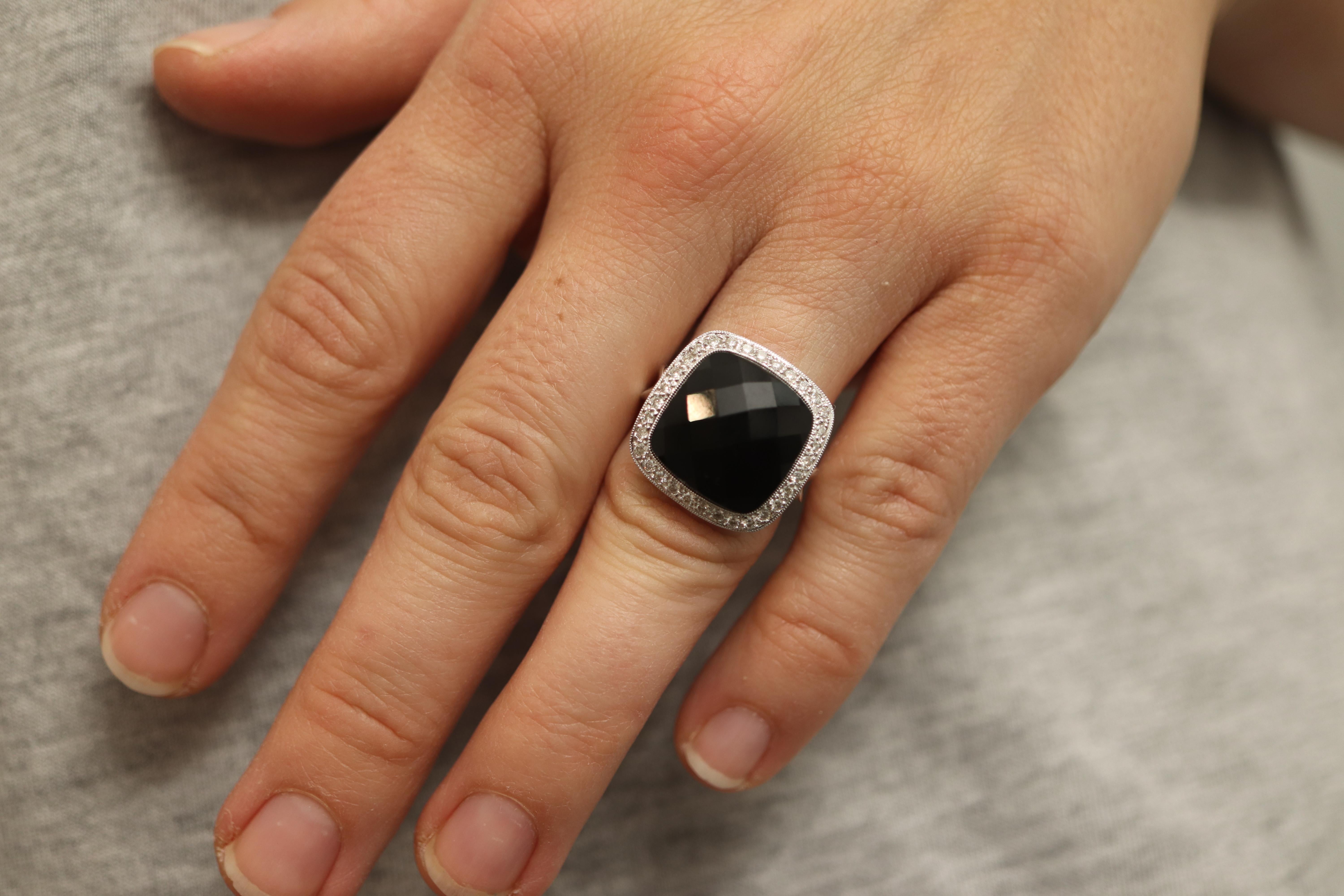 This is a super unique ring. Excellent ring that will stunning on any hand and any finger.

French Cut Checkered Cut Onyx sparkles from any angle.

Halo set diamonds around the perimeter.

18k Solid White Gold.


Details:
Size 6.5mm
15mm Onyx
1.5mm