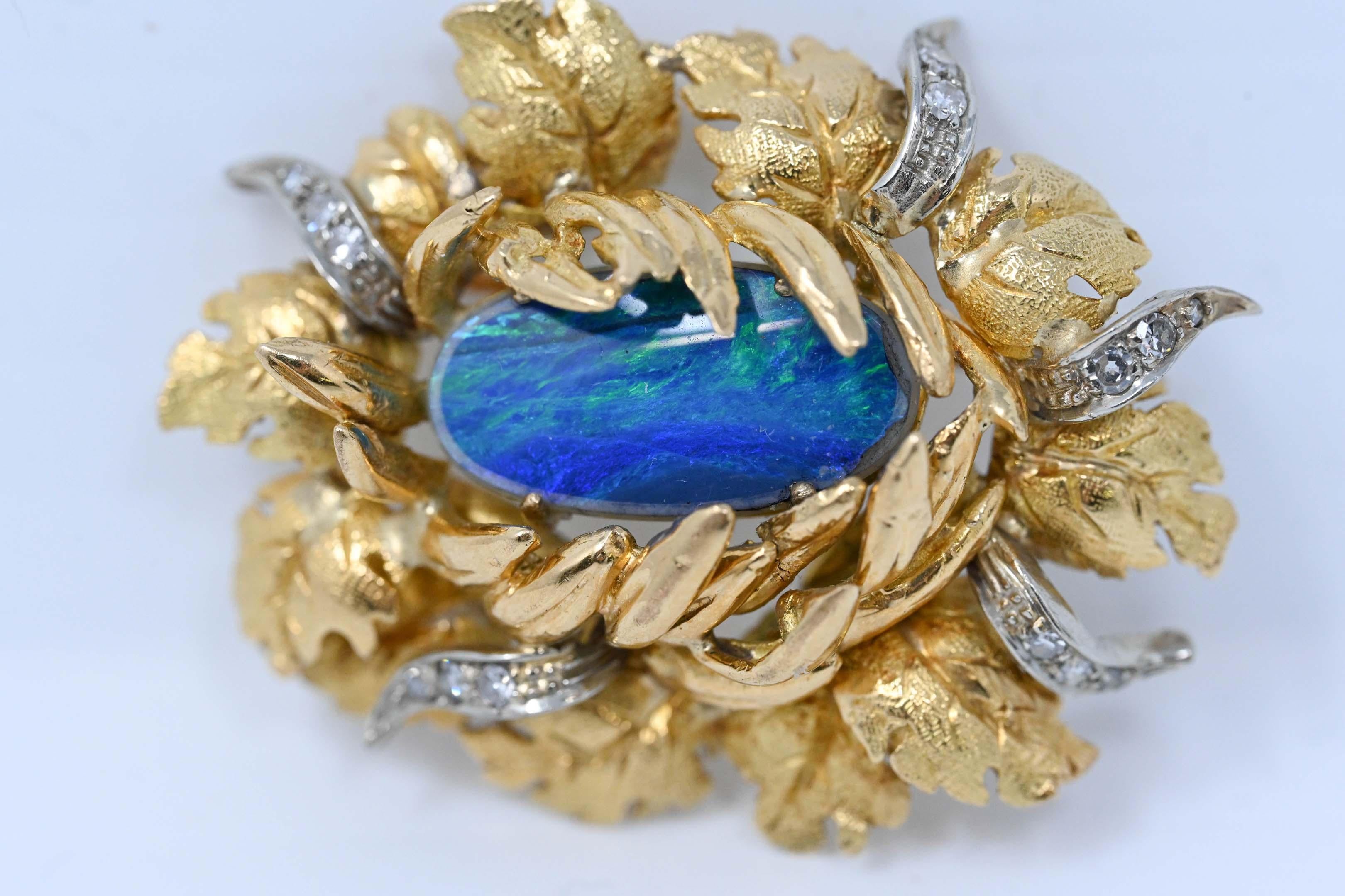 18k yellow gold , opal gemstone and 15 genuine diamond brooch. Unmarked, tested 18k, 40mm long x 33mm wide. Opal, measures about 18mm x 10mm. Maker unknown, weighs 13.9 grams.
