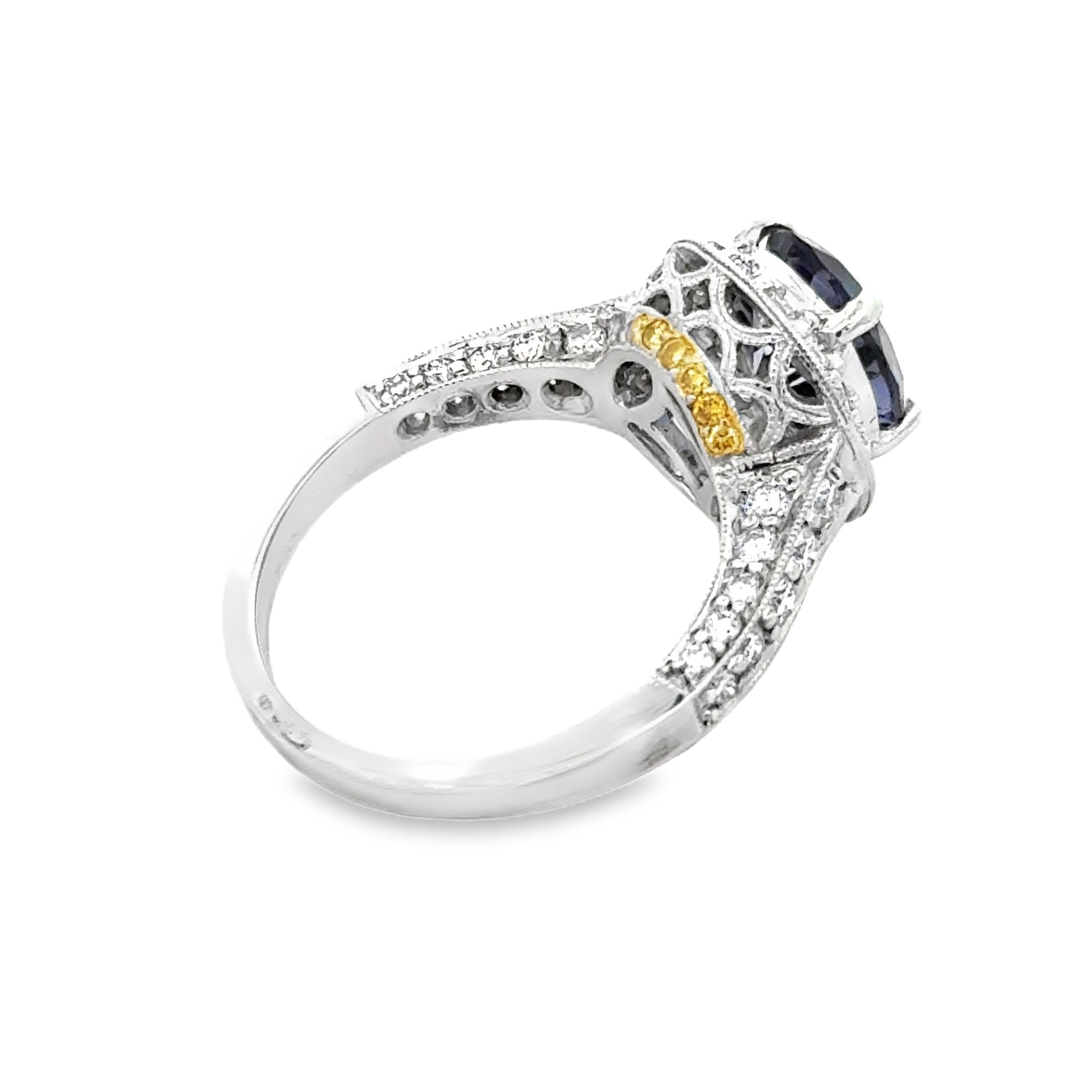 18K Gold Oval Iolite and White and Yellow Diamond RingThis 18K gold ring features a stunning 1.49 carat oval iolite, complemented by sparkling white and yellow diamonds. Crafted with precision and elegance, this ring is perfect for adding a touch of