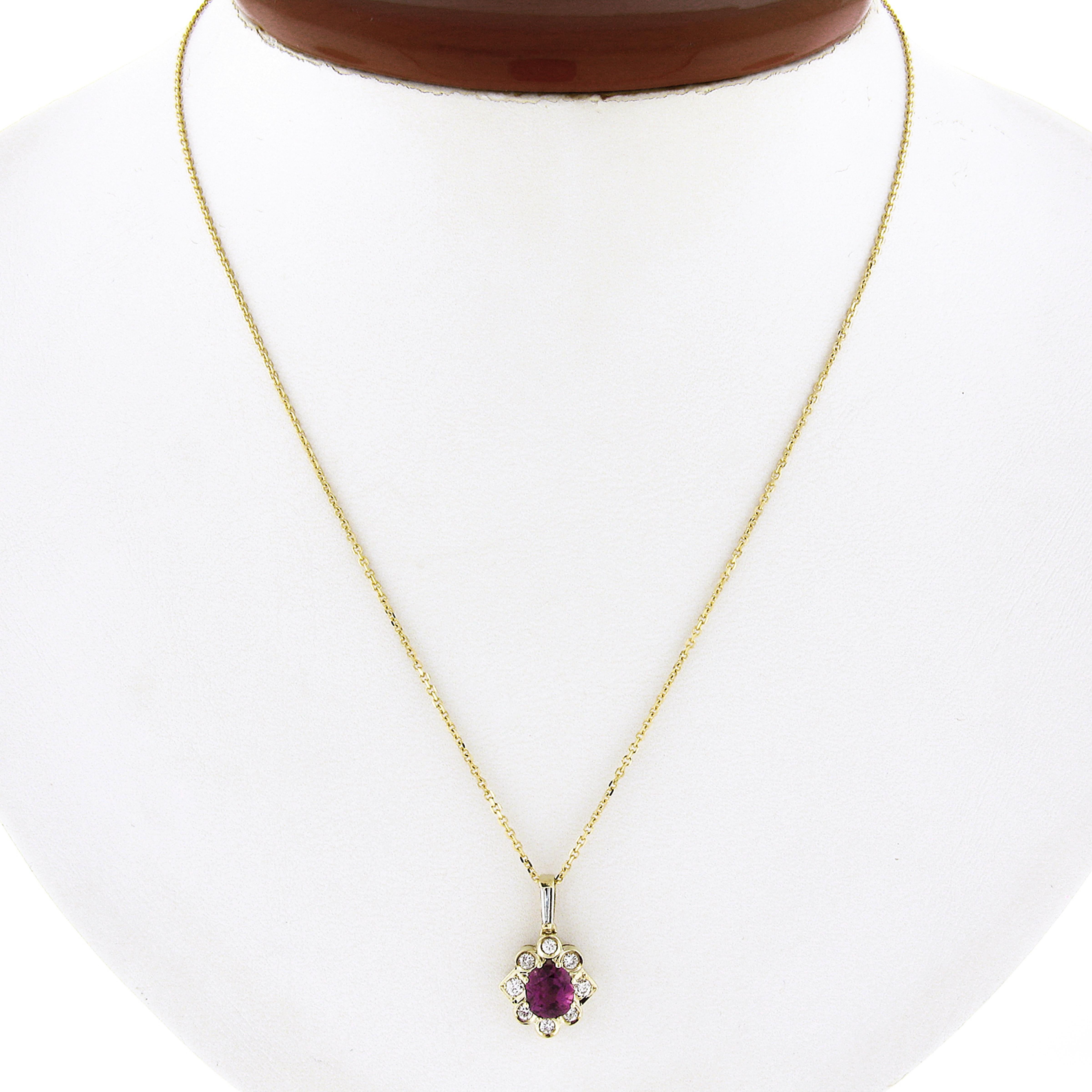 This beautiful pendant is crafted in solid 18k yellow gold with a 14k yellow gold cable link chain. It features a gorgeous oval stone tested as natural ruby or spinel that is pinkish red in color and neatly prong set at the center and further
