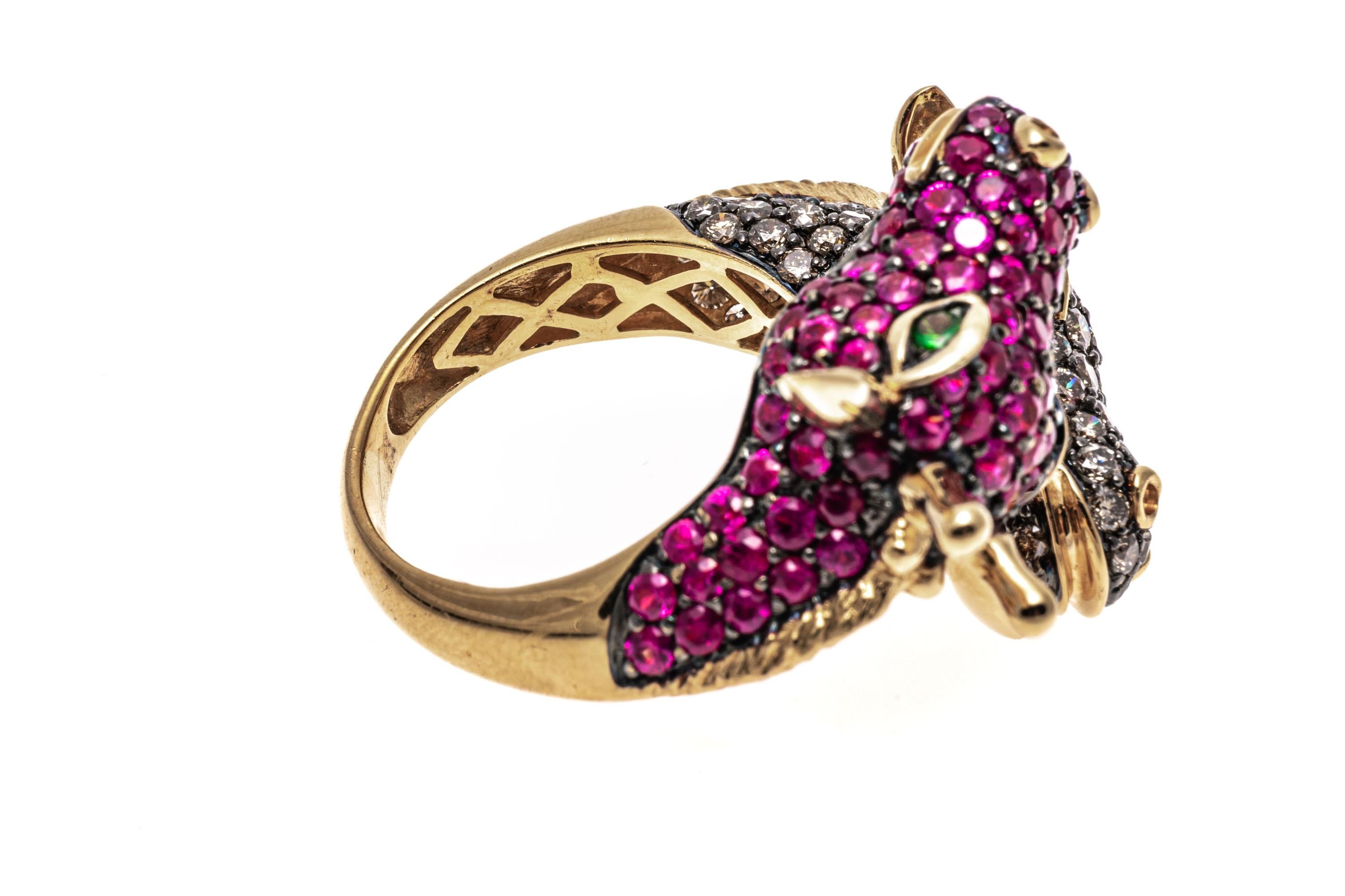 18k yellow gold ring. This cute and quirky yellow gold bypass ring has a center of opposing figural giraffe heads; one pave set with round faceted, cognac color diamonds, approximately 1.78 TCW and the other pave set with round faceted, medium pink