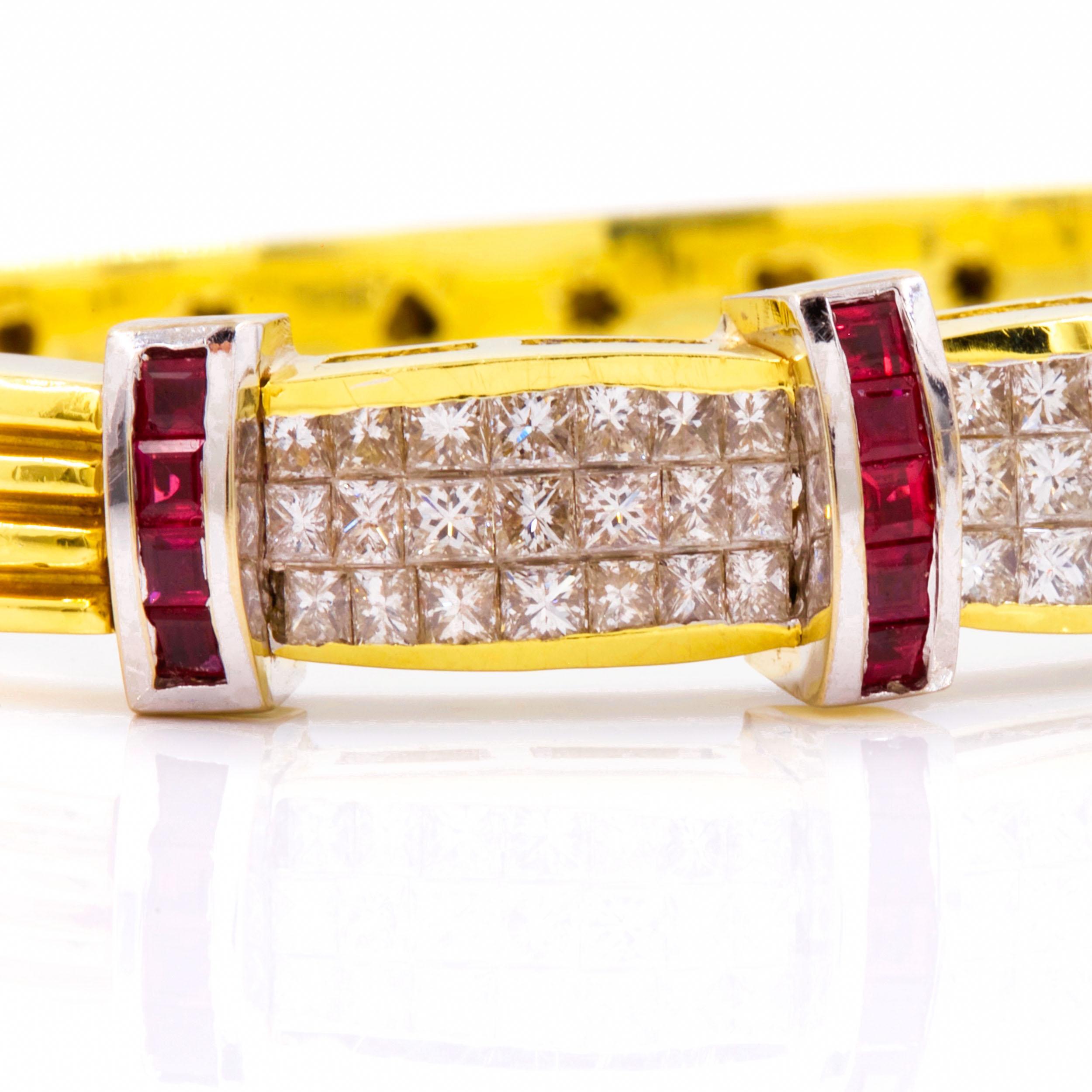 18K YELLOW AND WHITE GOLD RUBY AND DIAMOND BANGLE BRACELET
63 diamonds, 18 rubies, 58.5 grams total weight
Item # 012WGP03E 

An extremely fine bracelet crafted of 18k yellow gold with a reeded outer edge and a high-polish inner surface with stamped