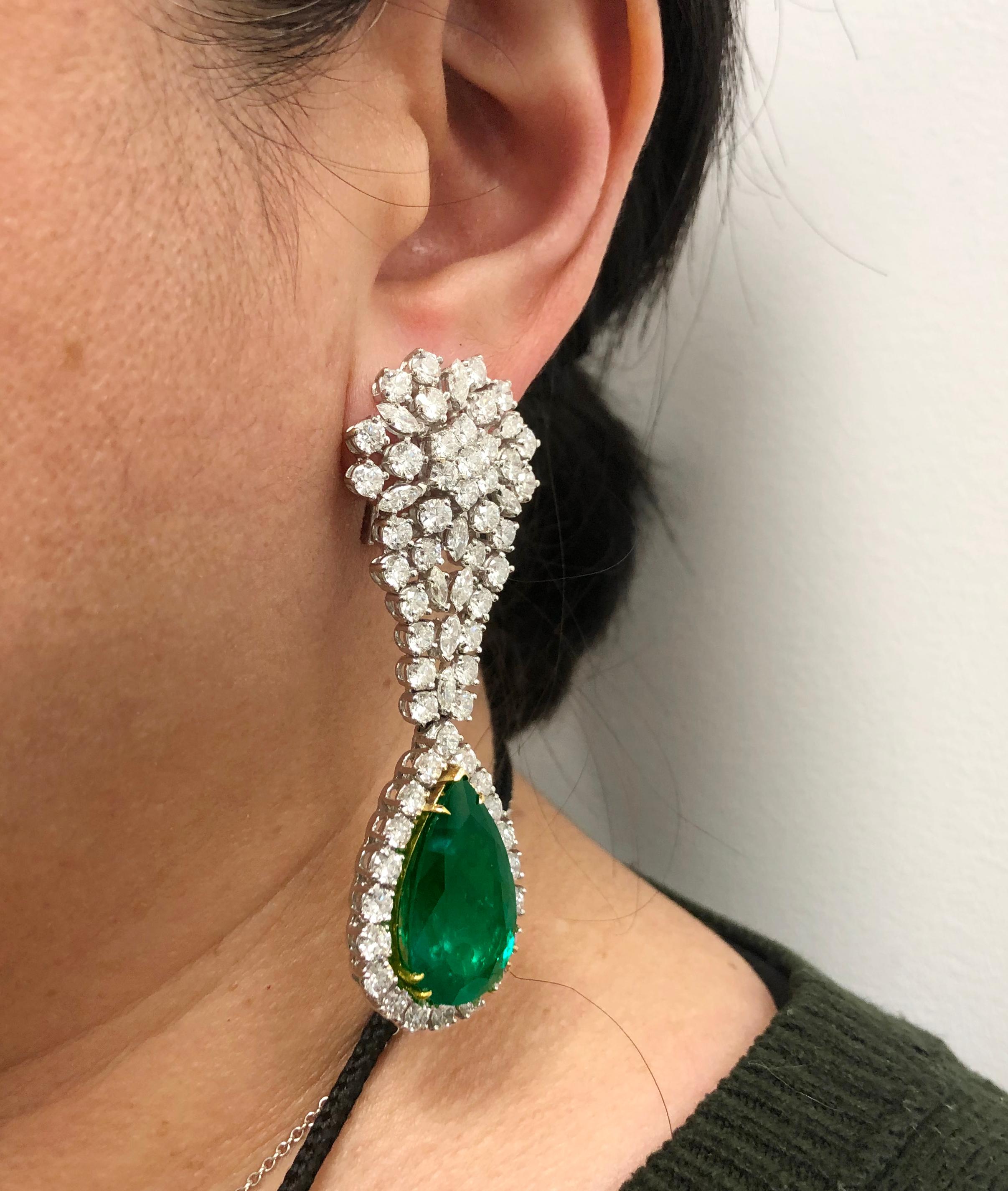 A unique pair of hanging earrings, crafted in 18k white gold, each featuring a large drop pear-shaped emerald, together weighing over 36 carats, surrounded by 15 carats of brilliant diamonds.  

Approx. 36.60 carats of emerald and 15cts. diamond