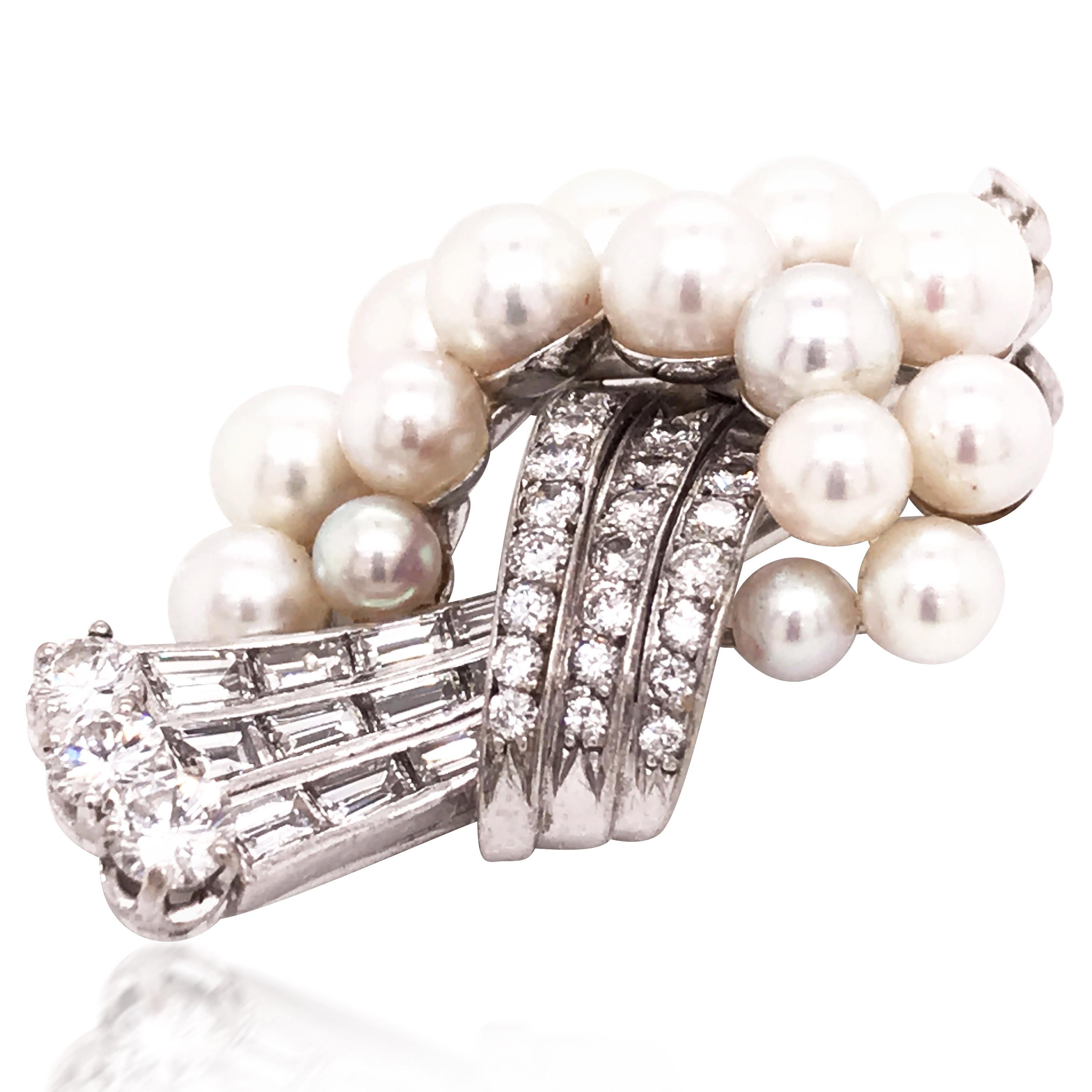 The brooch is circa 1950, composed of cultured pearls and a line of brilliant and baguette-cut diamonds.

Stamp: Swiss assay work and monogrammed.
Weight: 10.9 grams
Measurement: 3.8 x 2.4cm