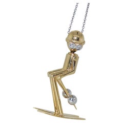 18K Gold Pendant of a Skier with Diamond Eyes