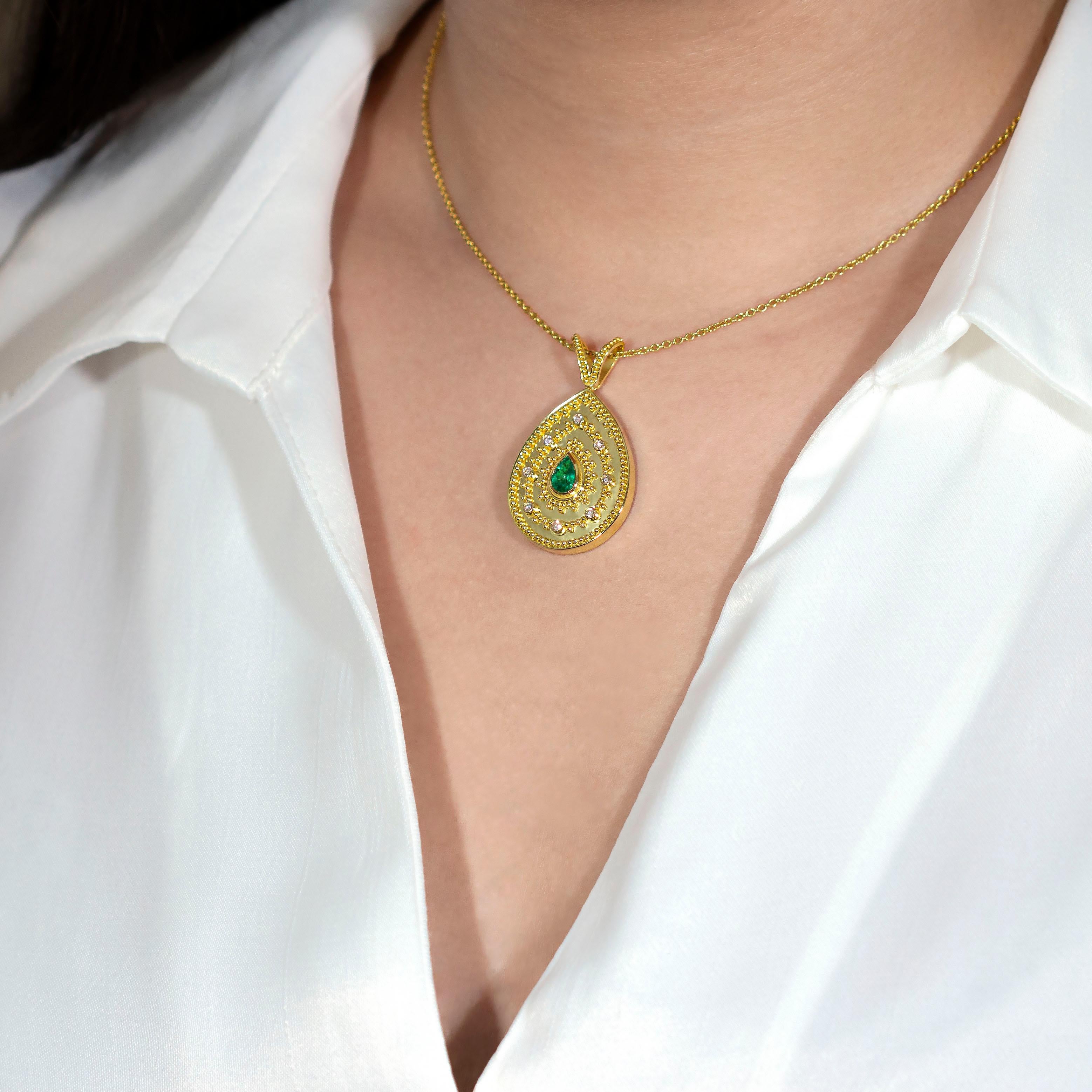 This beautiful gold pendant features stunning pear-cut emerald, accented with round brilliant-cut diamonds for added sparkle. With its timeless design, this piece of jewelry is sure to make a lasting impression.

100% handmade in our