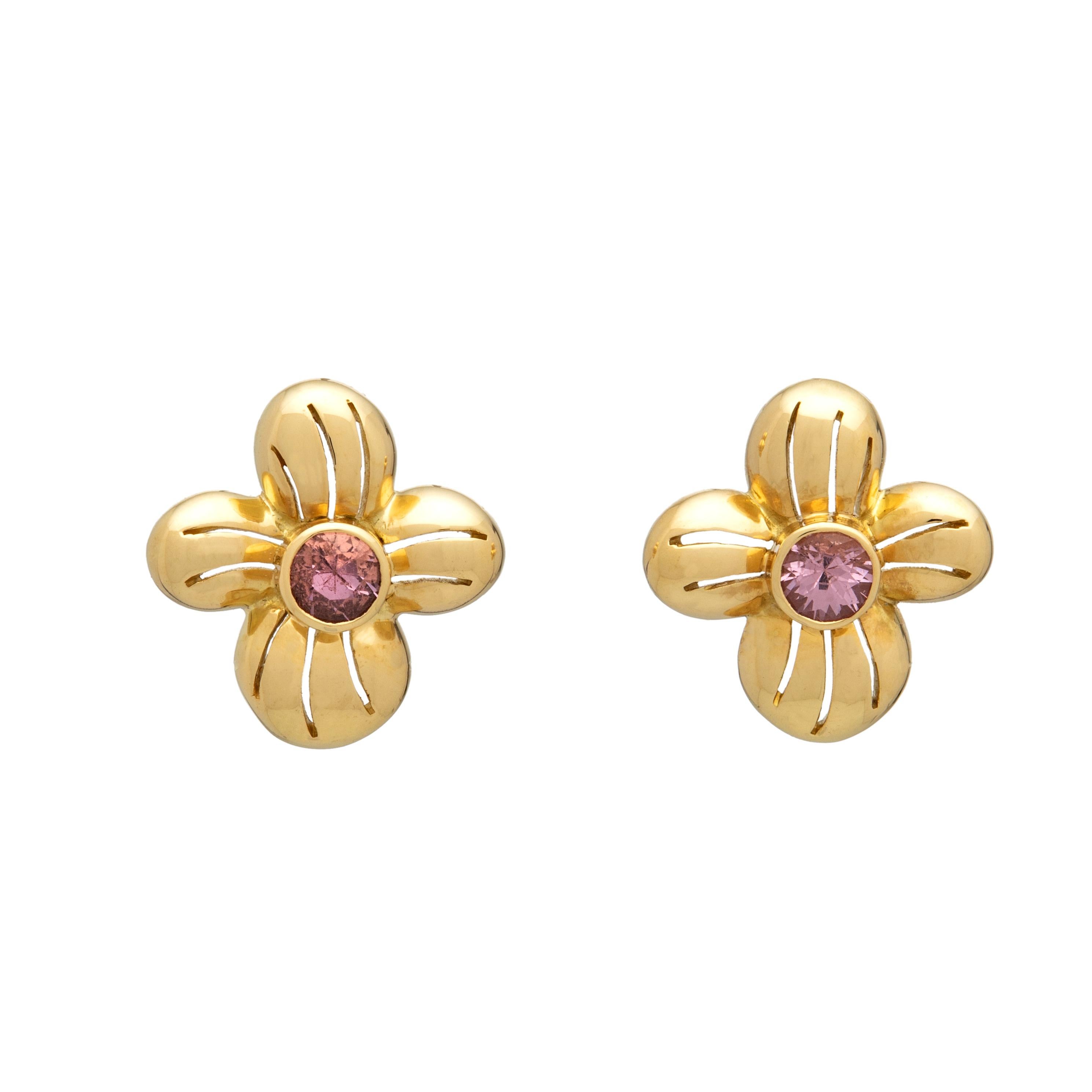 These 18k yellow gold earrings are crafted into flowers with pierced petals and a bright polished finish. Further enhancing these earrings are the two light pink spinels bezel set in the pistils of the flowers for an added punch of colour. Fun, yet