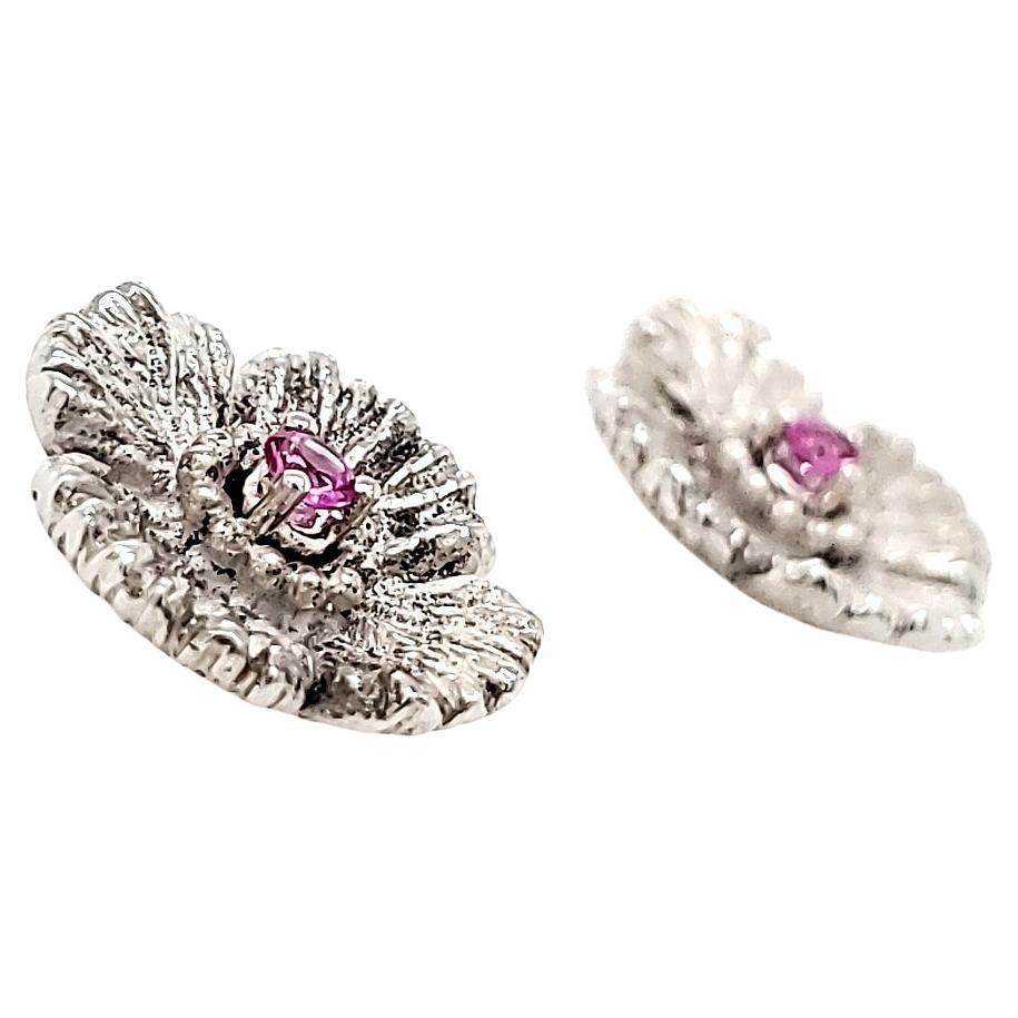 Nestled in the heart of each delicate flower, 2 pink sapphires totaling 0.18 cts capture the essence of romance and femininity. 

They are crafted from 18k gold, weighing 8.10 grams.

Pink sapphire is known to symbolize femininity, truth, love, and