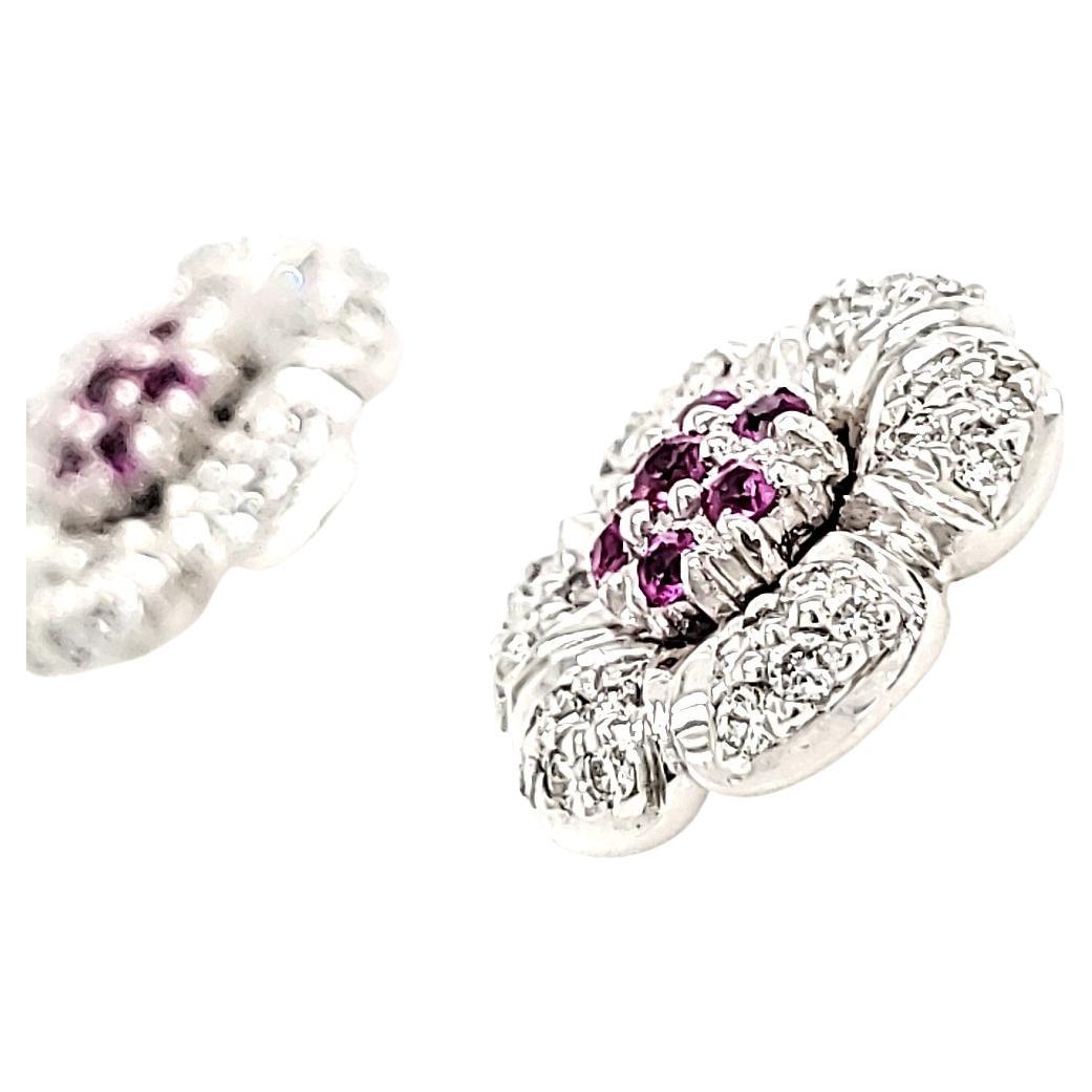 Delicately crafted with 14 lustrous Sri Lankan pink sapphires totaling 0.36 carats at the center.

Surrounded by 72 round diamonds totaling 0.60 cts, forming exquisite petals that shimmer with every movement.

All set in 18k gold purity, weighing
