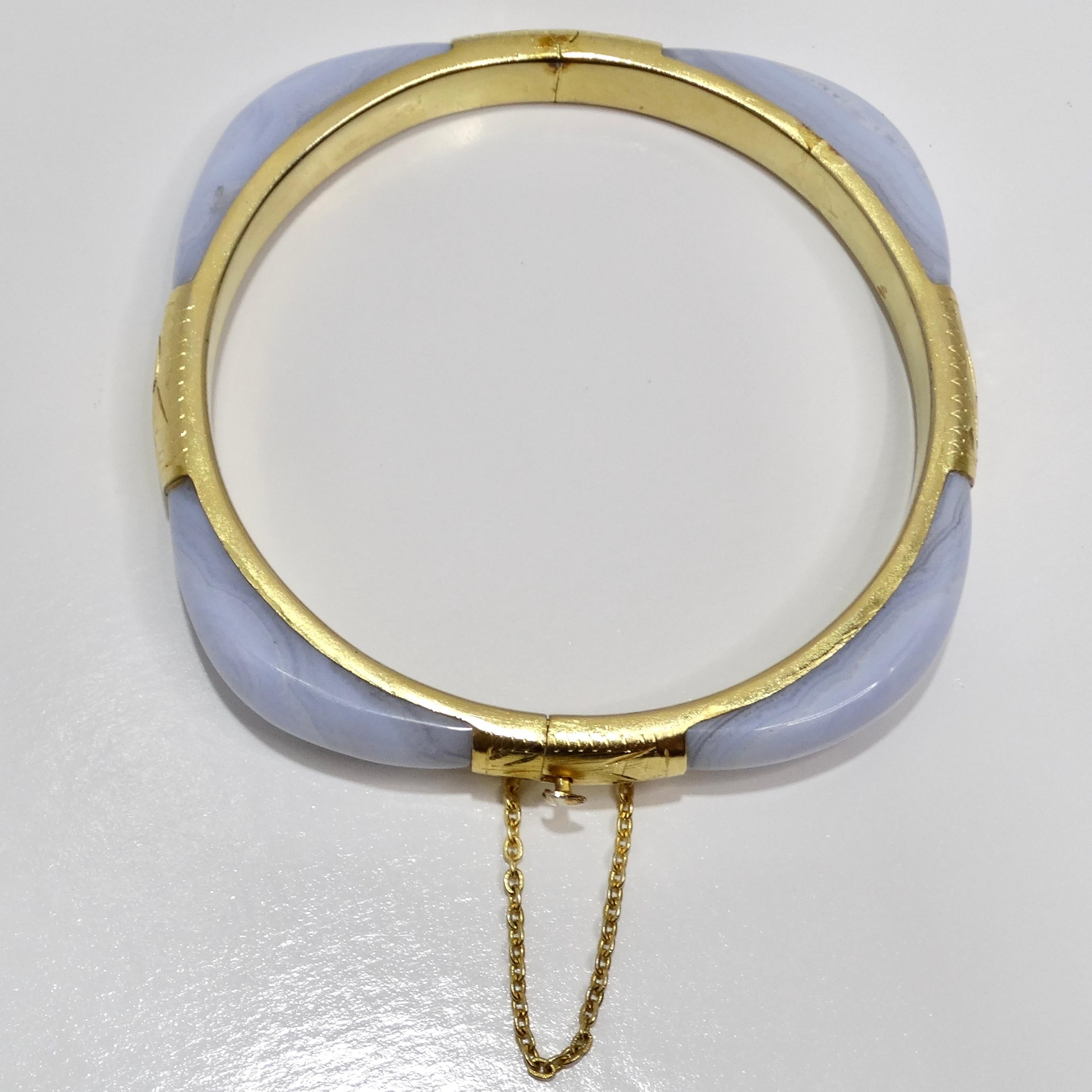 Introducing the 18K Gold Plated 1960s Blue Stone Cuff Bracelet, a stunning vintage piece that blends classic elegance with a touch of vibrant color. This beautiful cuff bracelet features a striking light blue stone, set in a luxurious 18K yellow