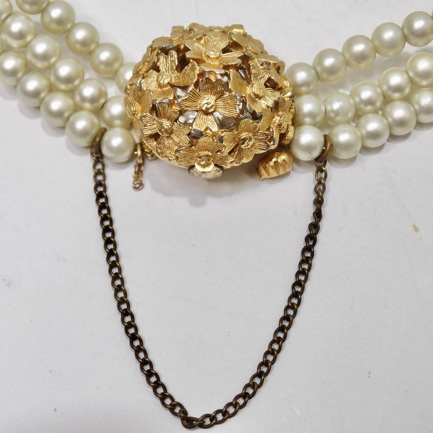 Do not miss out on this incredibly special vintage hidden watch pearl bracelet circa 1950! The most unique multi-strand pearl bracelet featuring 18K gold plated flower motifs throughout as well as a brass drop chain as a contrasting detail. The star