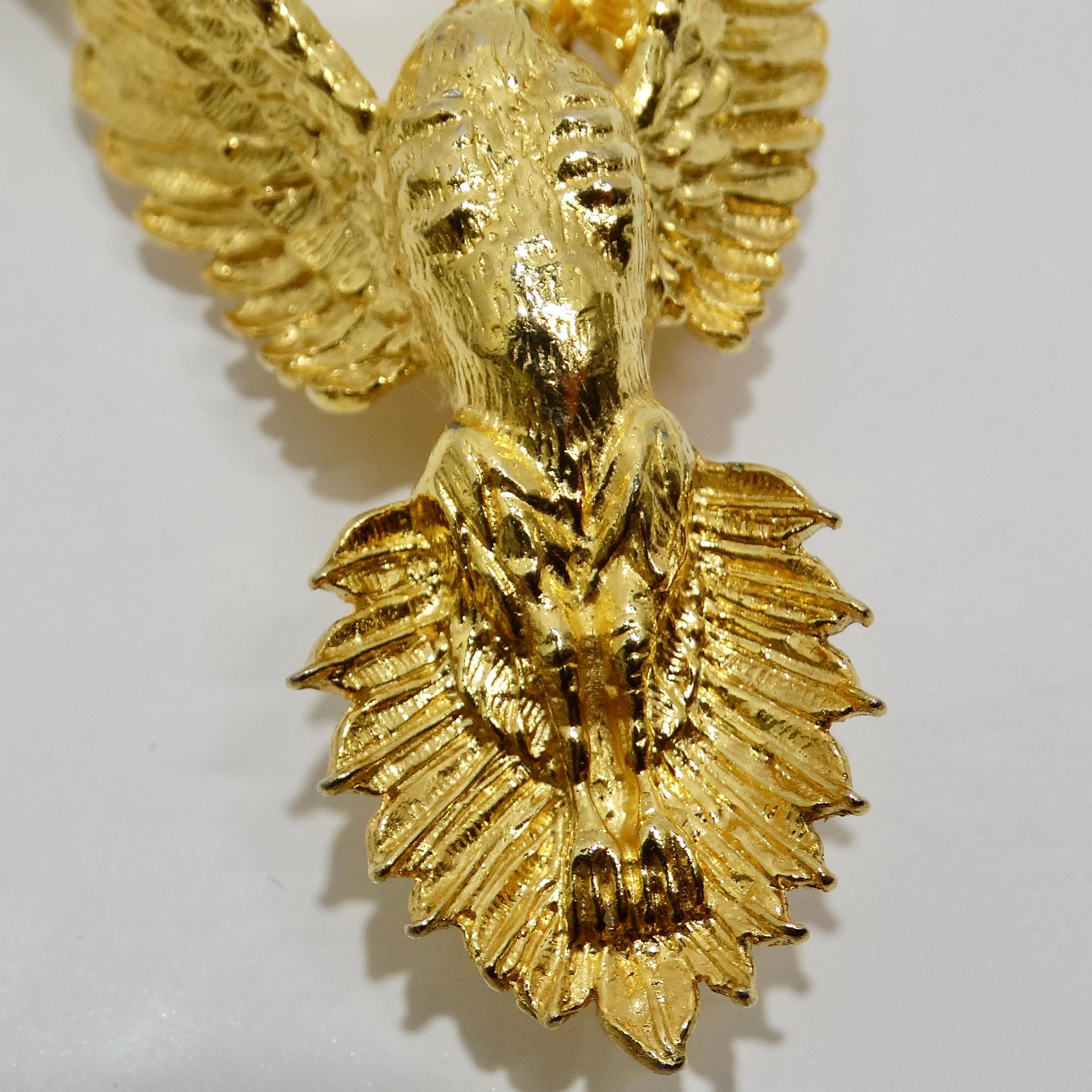 Introducing the 18K Gold Plated Vintage PhoenixBrooch, a stunning piece from the 1970s that combines luxury with a bold design. This remarkable brooch features an intricately crafted eagle, symbolizing strength and freedom. The 18K yellow gold