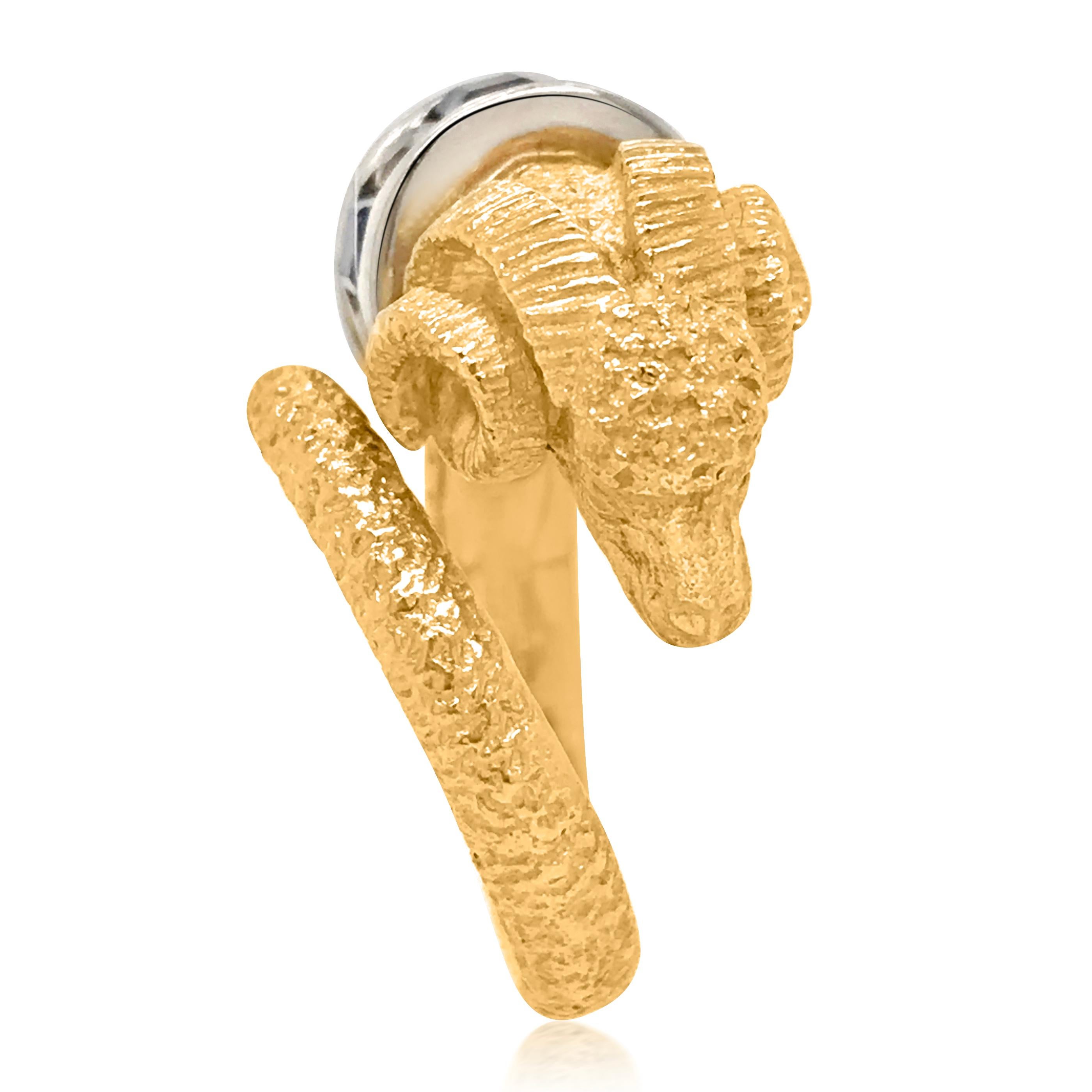 This artfully designed gold ring features a ram head, crafted in a combination of 18K yellow gold and platinum, it is adorned with 4 round-cut yellow diamonds weighing approx. 0.32 carats, graded VS/SI and 3 square-cut sapphires approx. 0.60 carats.