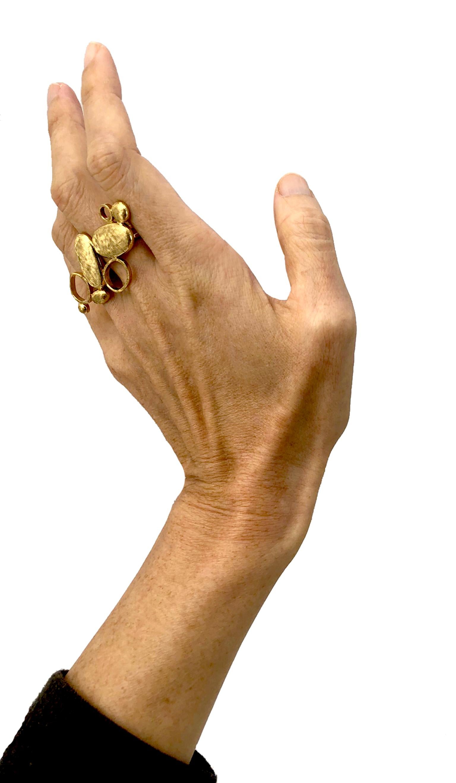 A Post Modern well crafted 18K Gold crossed-finger ring. 

A powerful statement piece decorated from the top to the back of your hand. This hand made ring fits comfortably. 

The interior diameter measured 16 mm. Size: appx 5.5 US 
Finished: