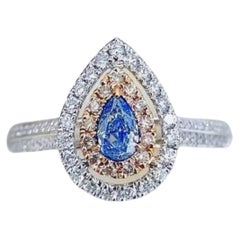 18K Gold Ring Rare Teardrop Cut Blue Diamond Encircled by Dazzling Halo