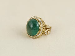 18K gold ring set with an 18 ct natural Emerald Cabochon and natural diamonds