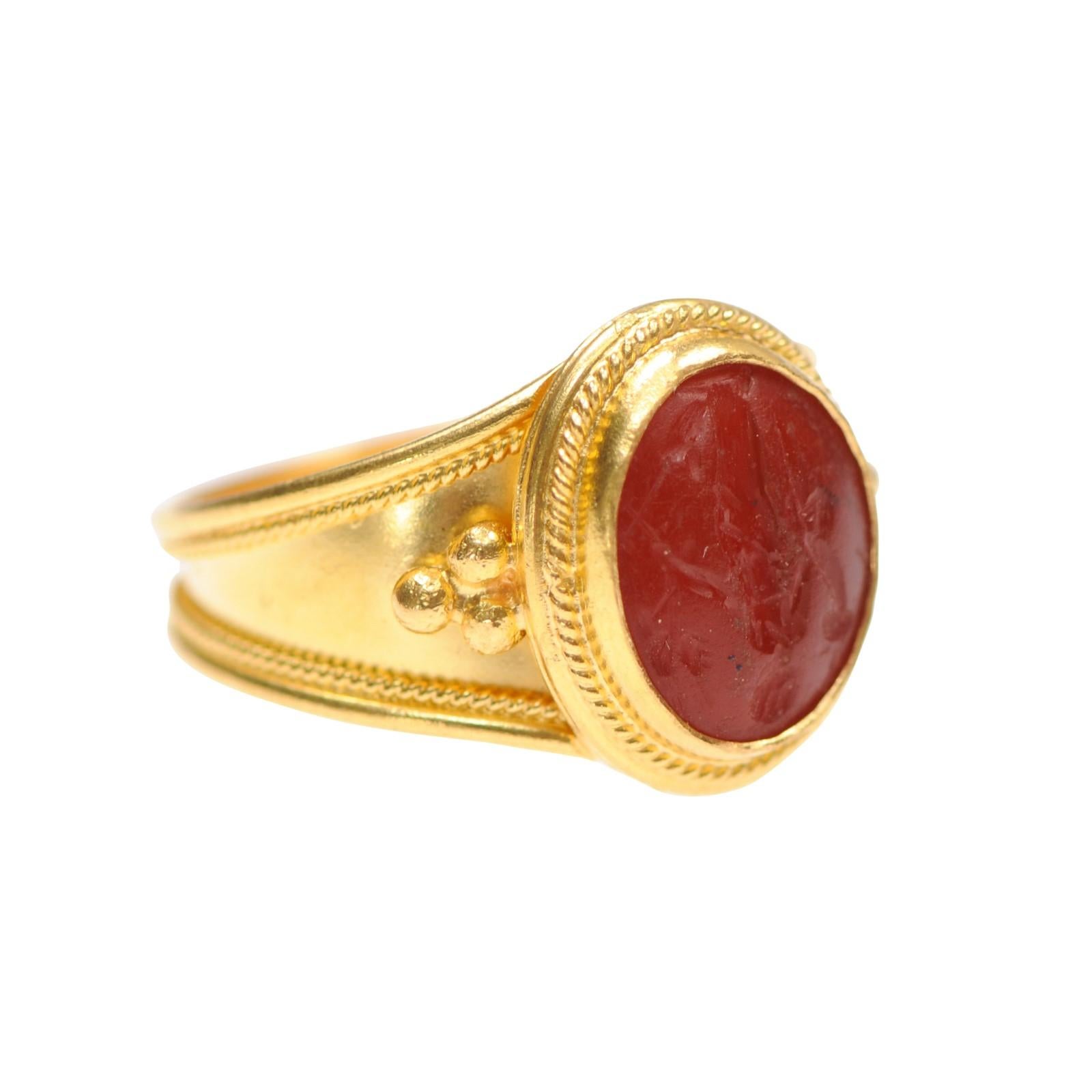 A hand crafted 21 karat gold ring made with an authentic Carnelian intaglio representing Venus (or Aphrodite, as she was called during the time it was made). Aphrodite is the Greek goddess of love and beauty. The time period of this intaglio is from