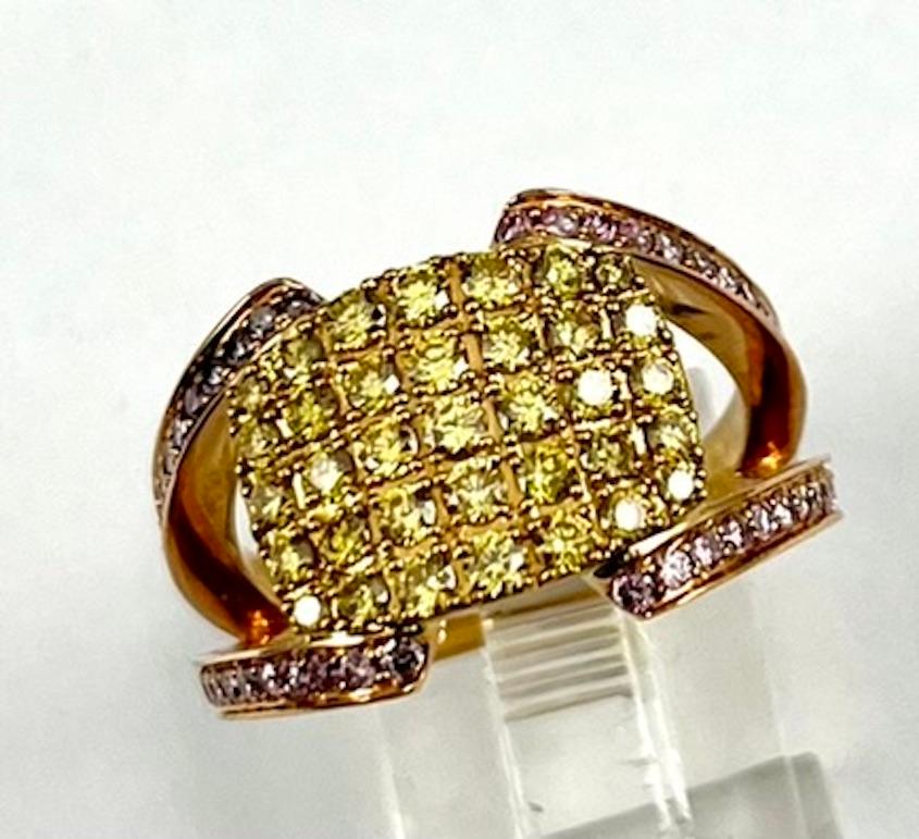 This is an elegant and modern band set with 35 Natural Round Intense Yellow Diamonds of .81Ct Total Weight and Natural Round Intense Pink Diamonds of .61Ct Total Weight. The design of the ring maximizes the appearance of the colored diamonds and