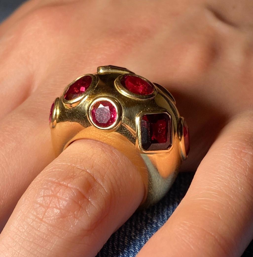 Discover the allure of this captivating 18-carat gold ring, meticulously crafted to perfection. It showcases a harmonious blend of enchanting gemstones, including round cut and pear cut rubies, octagonal cut and pear cut rubellite tourmalines, and a