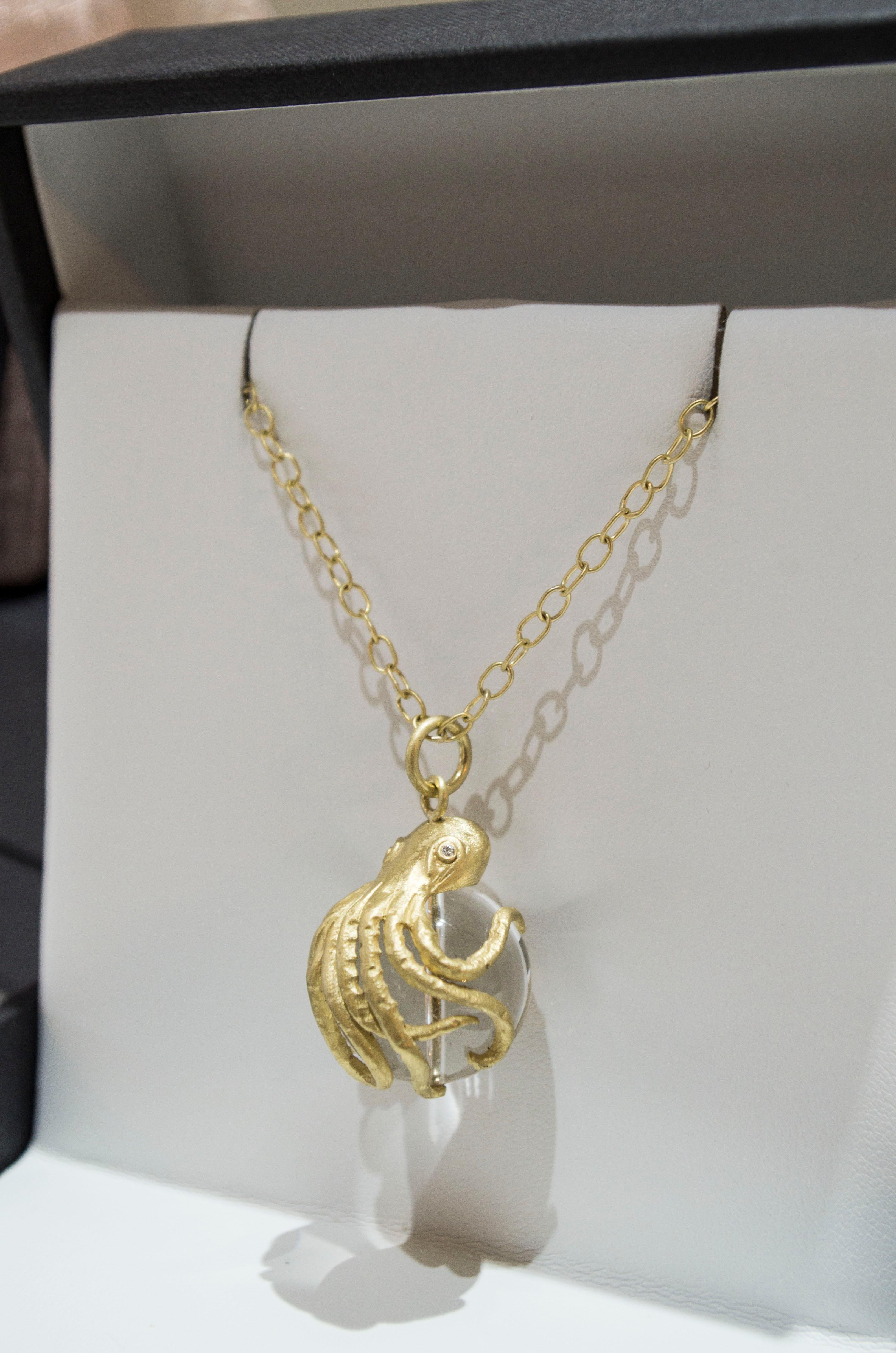 Fall in love with Faye's gold Octopus pendant.  With its eight arms embracing a Rock Crystal Quartz bead and bright diamond eyes, it's a whimsical treasure from the sea. Chain is handmade in 18k gold. 28