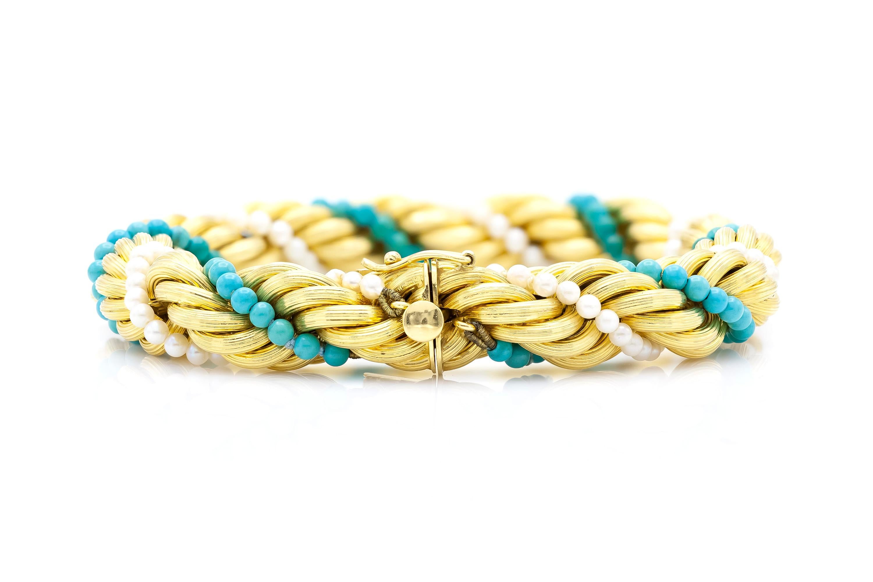 Finely crafted in 18k yellow gold with Turquoise beads and Pearls.
Size 8 1/8 inches.