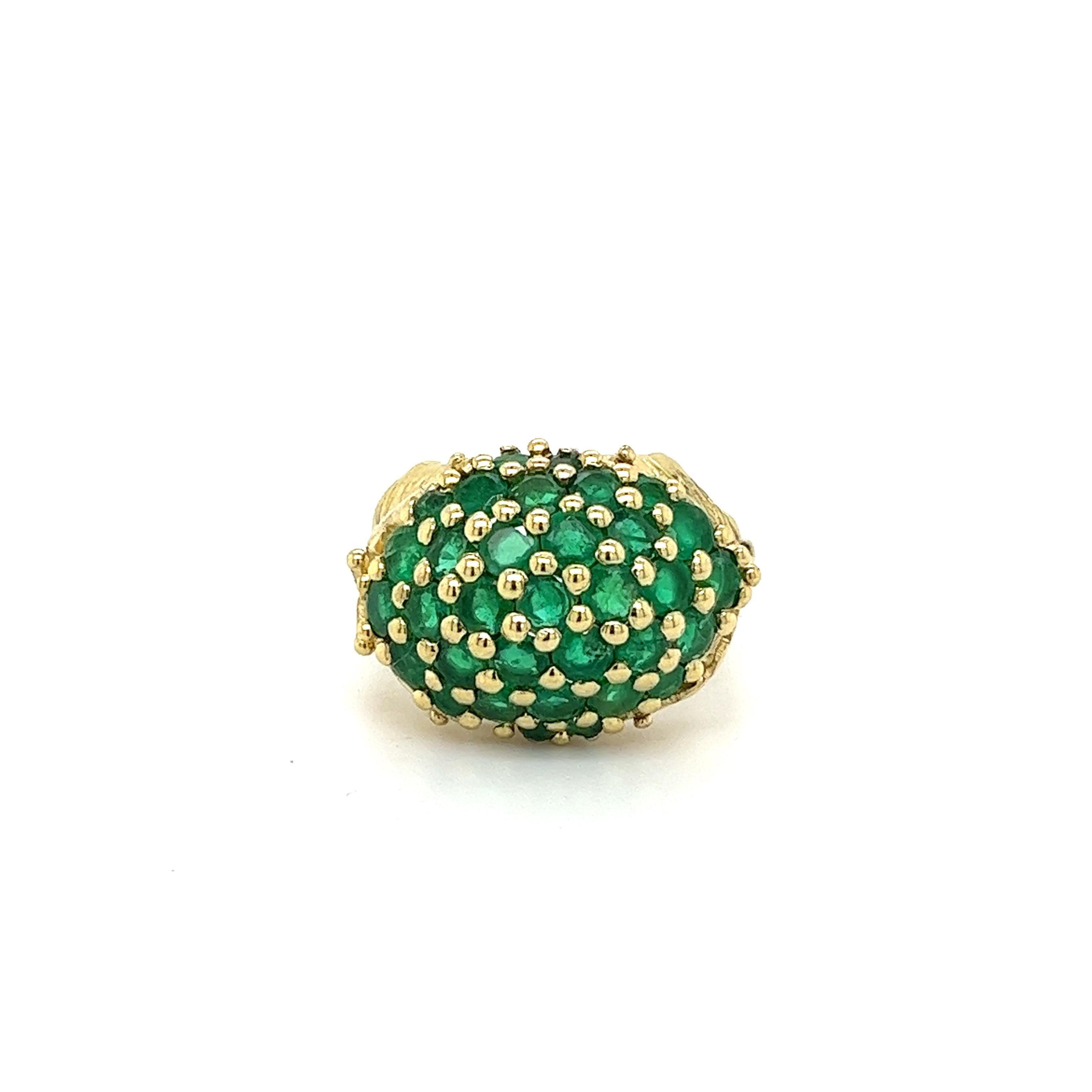 Natural round cut emerald cluster ring with a carved leaf detail is a stunning piece of jewelry that combines classic elegance with a leaf-inspired design. The ring features a cluster of tensions set emerald gemstones set in a circular dome