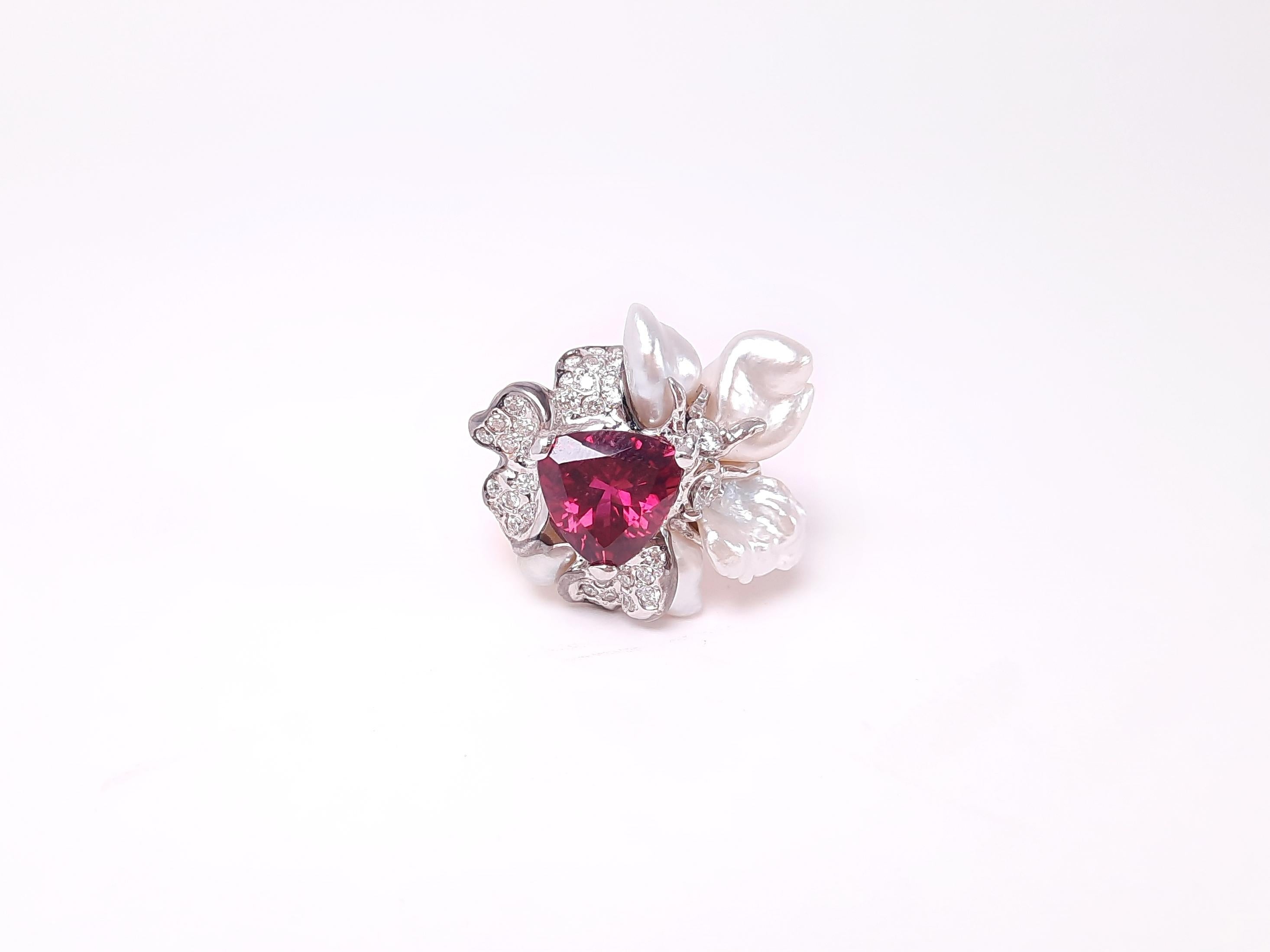 
Inspired by the vivid brushstrokes of Impressionism and the beauty of Van Gogh’s masterpieces, this handcrafted ring is a wearable work of art. At its heart, a 2.29ct deep-hued rubellite glows like a ripe fruit or a beating heart, embraced by