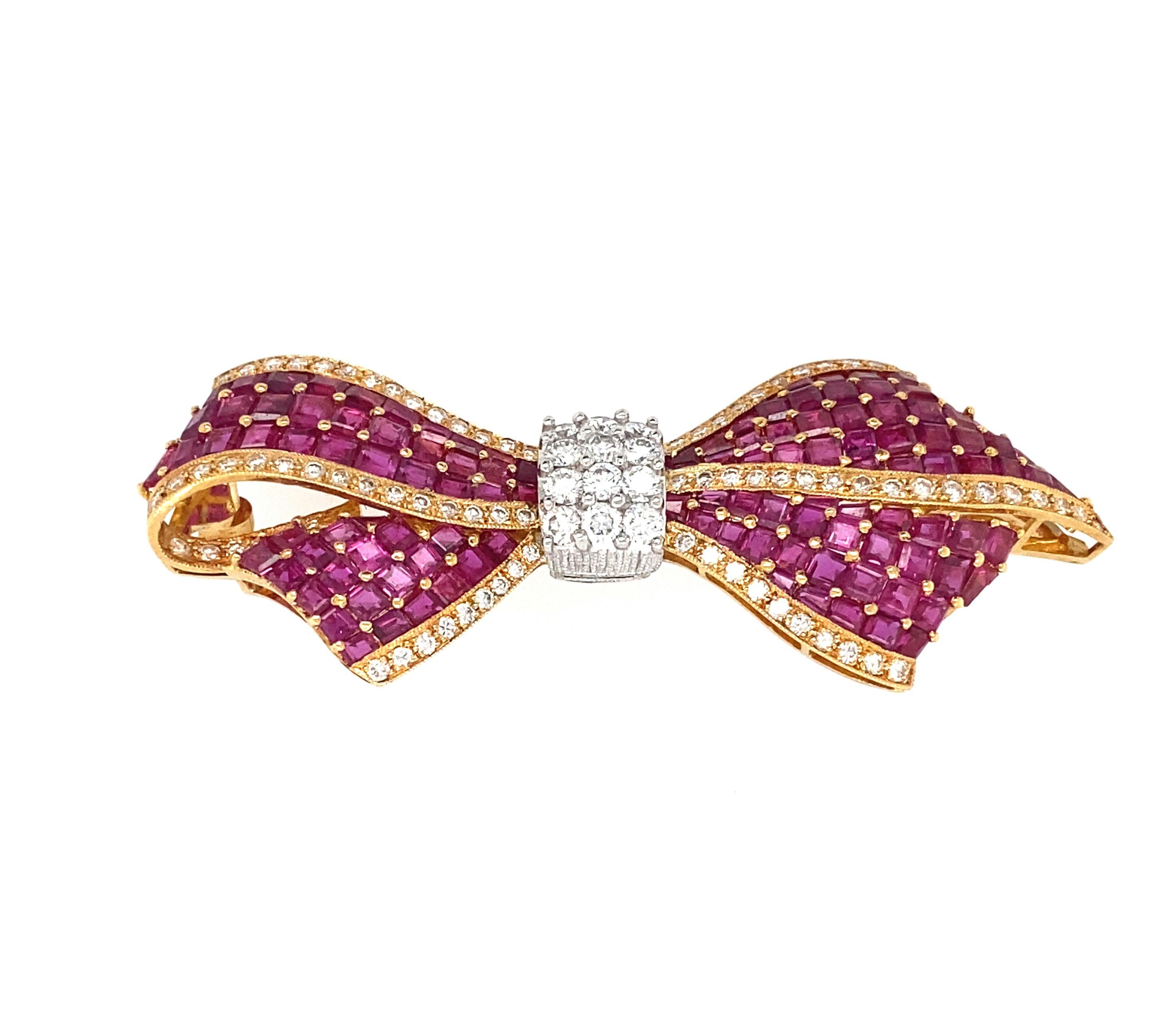 PLATINUM AND 18K YELLOW GOLD 10.00 CARAT RUBY AND 1.6 CARAT DIAMOND BOW BROOCH BY OSCAR HEYMAN
stamped PT 750 74164, round cut diamonds, color G/H, clarity VS, approx. 2cttw., calibre cut rubies, clarity VS, weight approx. 10 carats, 
measurement