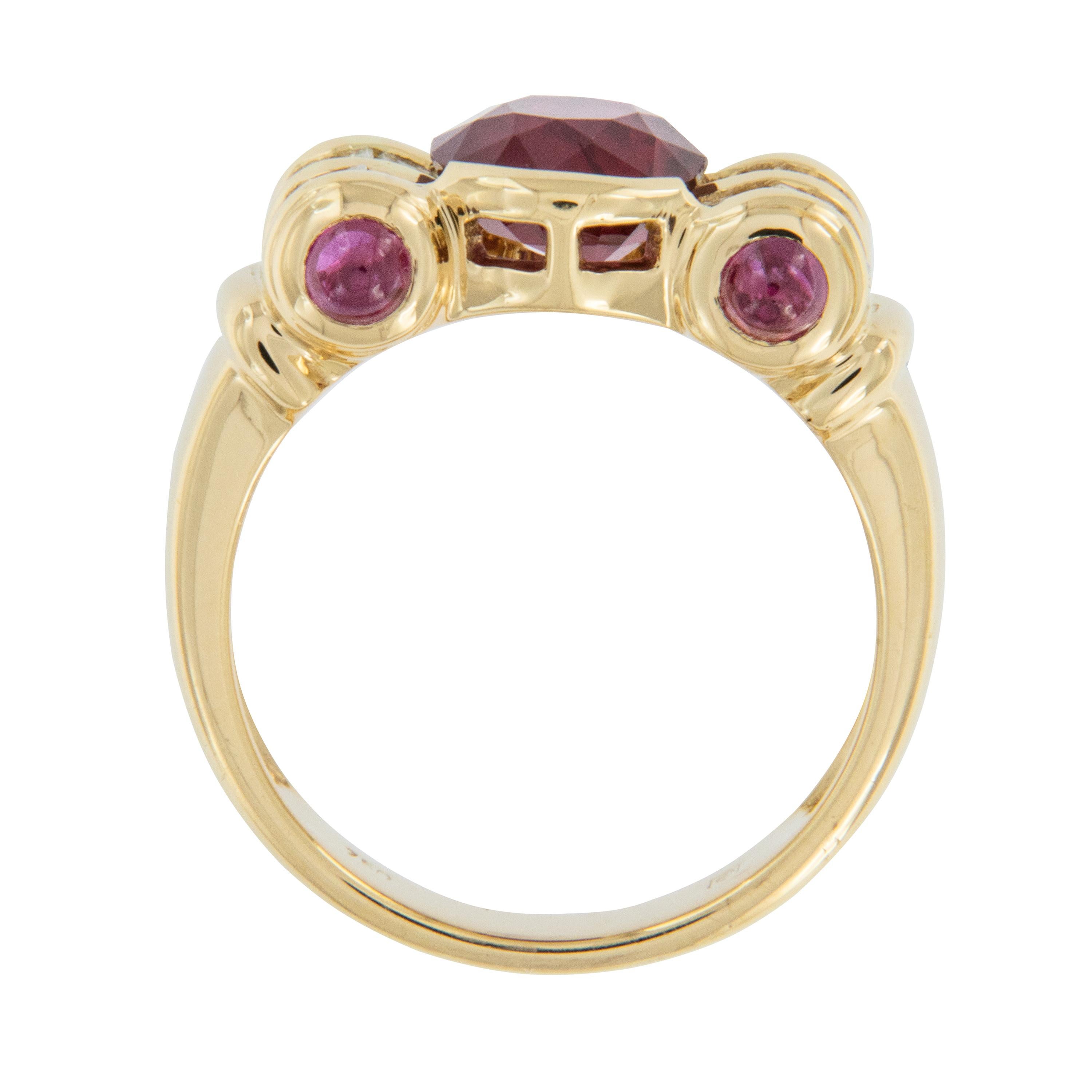 2000 ago rubies were discovered in India and the Sanskrit word for ruby is “ratnaraj” which roughly translates to “king of the gems.” This 18 karat yellow gold, royal red ruby ring with sinuous rolled top has 1 oval ruby & 4 cabochon cut rubies =