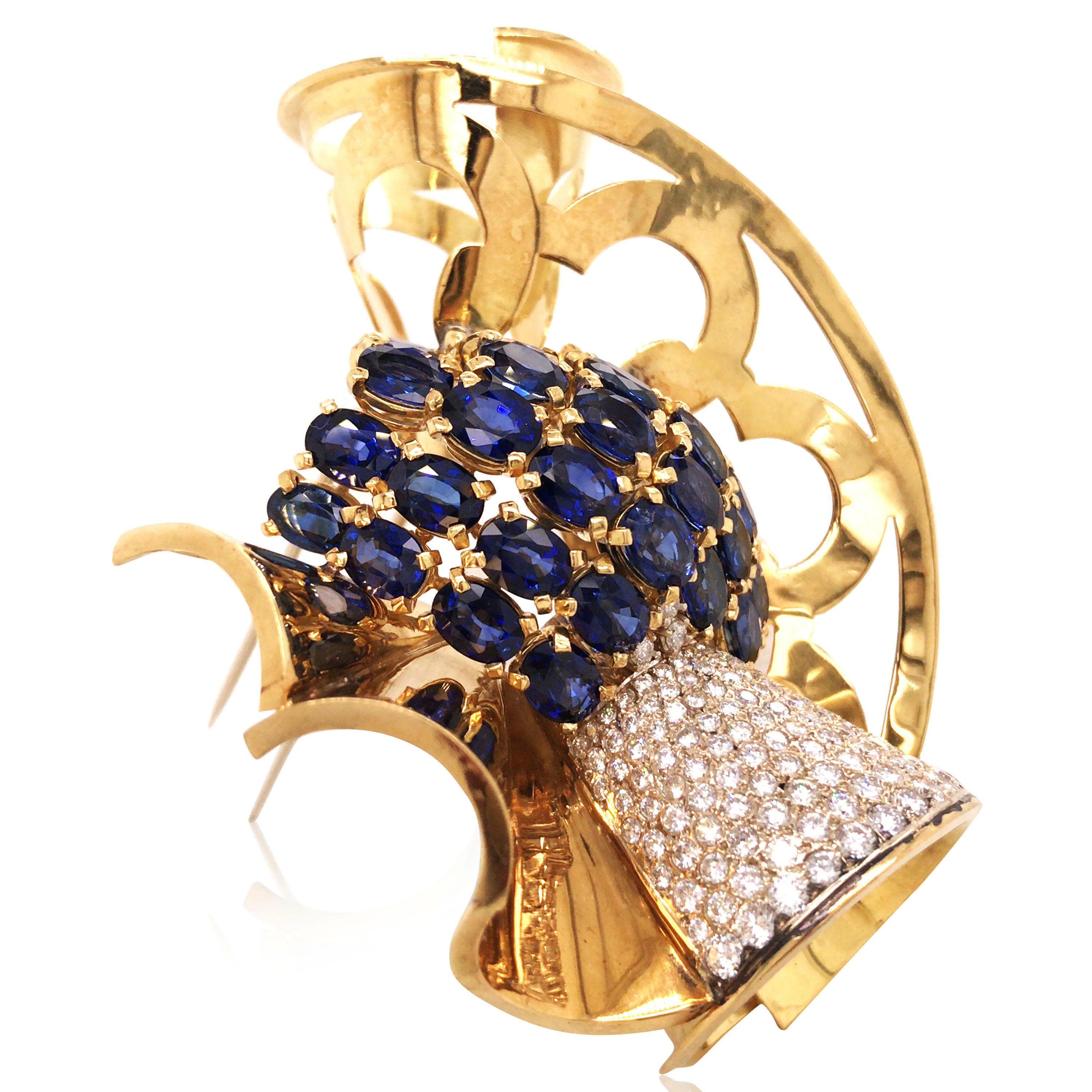 Designed as a scrolling openwork brooch with conical shaped elements, one pavé-set with circular-cut diamonds, total approx. 6.0ct, centered by oval-cut sapphires; sapphire total approx. 15.0ct.

Weight: 57.4 grams
Measurement: 8.3 x 6.4 x 2.5 cm 