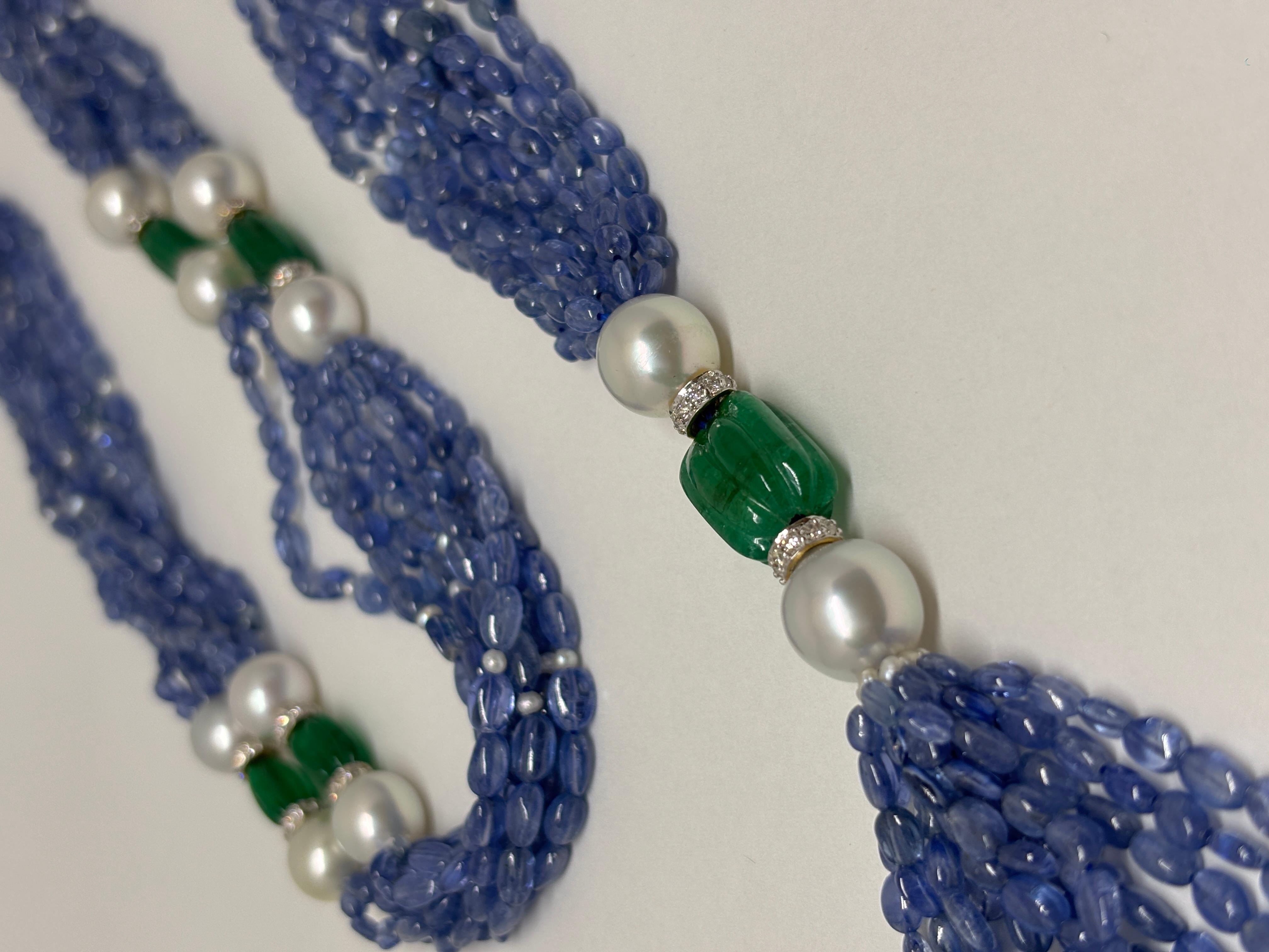 This exquisite 34-inch necklace, with an additional 4.5-inch drop, combines 373 carats of stunning Burmese sapphires and intricately carved Zambian emeralds with radiant South Sea pearls (138 carats), adding a touch of timeless grace. 

The