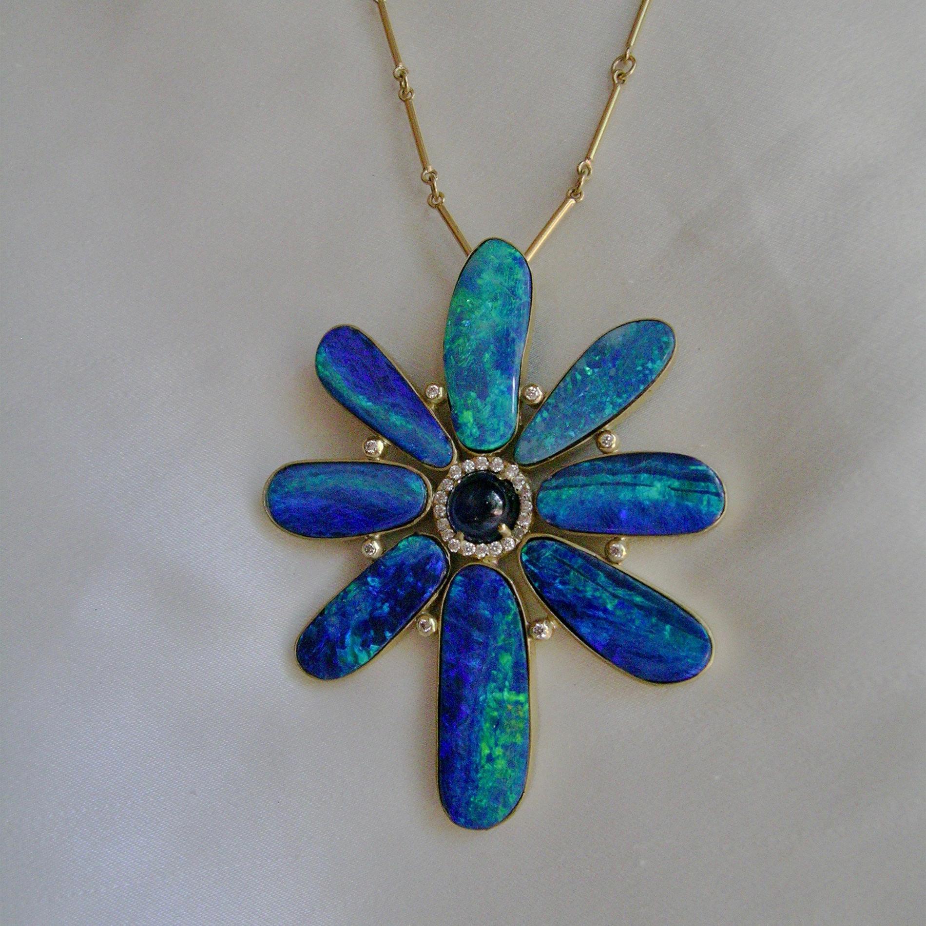 This is a dramatic piece and makes a bold, colorful statement.  If you love flower pendants, but they often are too small for your frame, here is something for you.  11.5 cts of Boulder Opals from Australia create the unique flower shape, with a