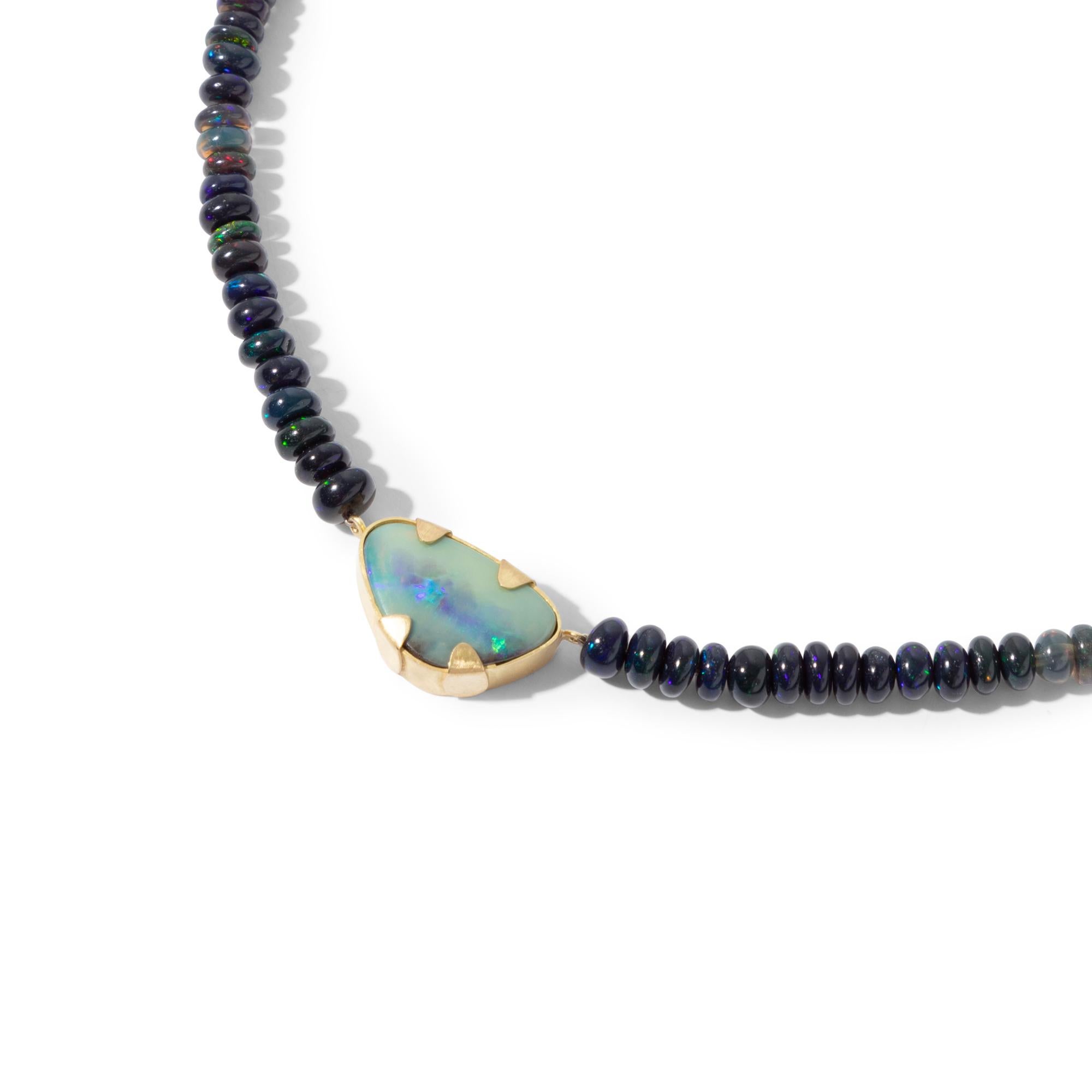 A lovely and intriguing necklace with a mesmerising natural Australian black opal pendant strung on dark opal beads. The iridescent stripe across the boulder opal shows plenty 