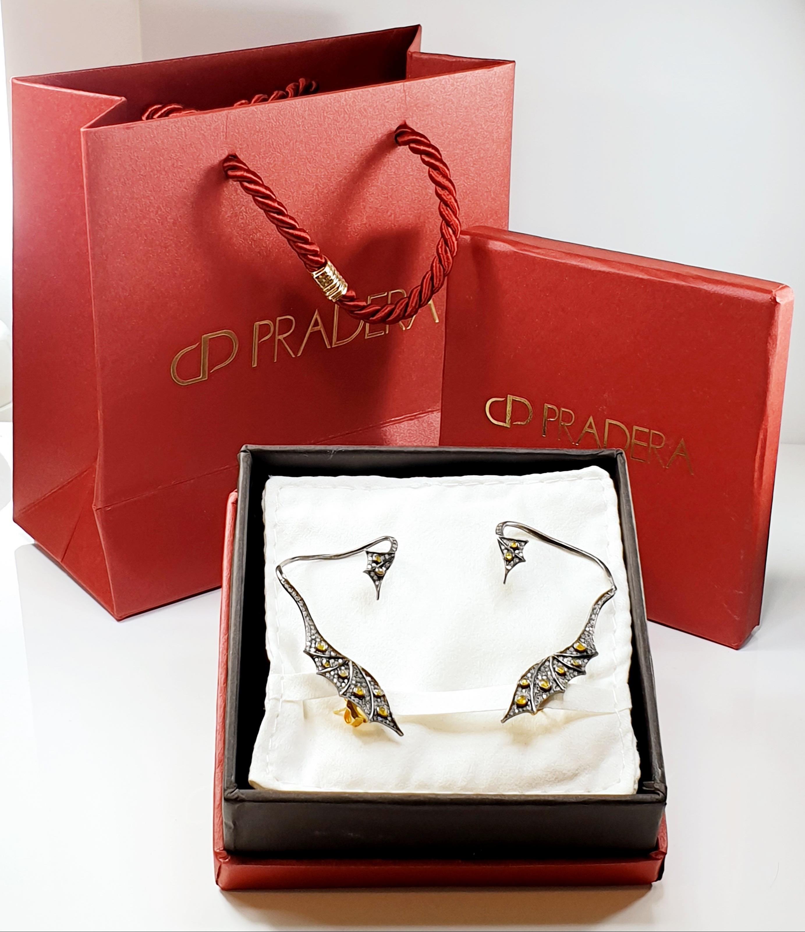 Sophisticated and modern cuff dragon Earrings with diamonds and cabouchon yellow saphires 
Irama Pradera is a Young designer from Spain that searches always for the best gems and combines classic with contemporary mounting and styles. 
Sleekly