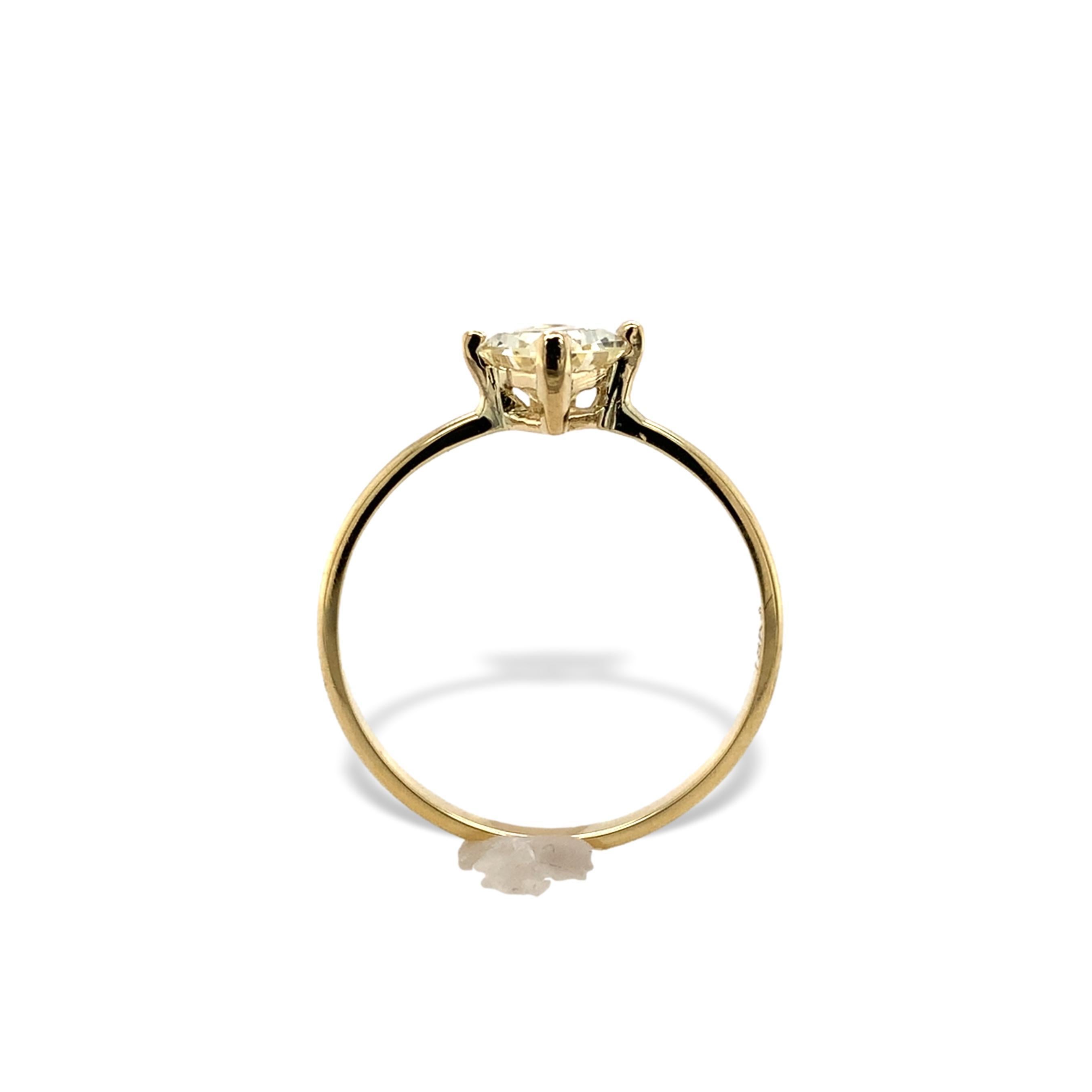 18K yellow gold ring featuring a 1.04 carat yellow sapphire. The sapphire is a pale yellow color and fancy shape modified shield cut. The sapphire has a CSL card stating natural unheated and measures 8.10mm x 6mm x 3.5mm. The ring fits a size 7.0