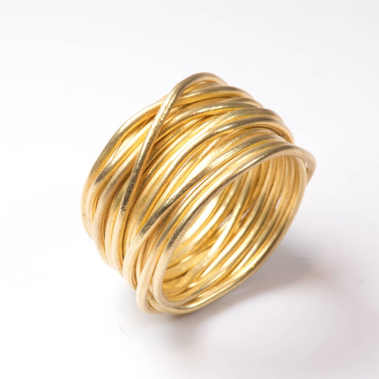 18k yellow gold wire ring. 1mm wire has been lightly textured using traditional forging techniques. One continuous length is wrapped and shaped to form a 9mm wide contemporary and stylish ring. The 'Spaghetti Ring' is a classic design from Disa