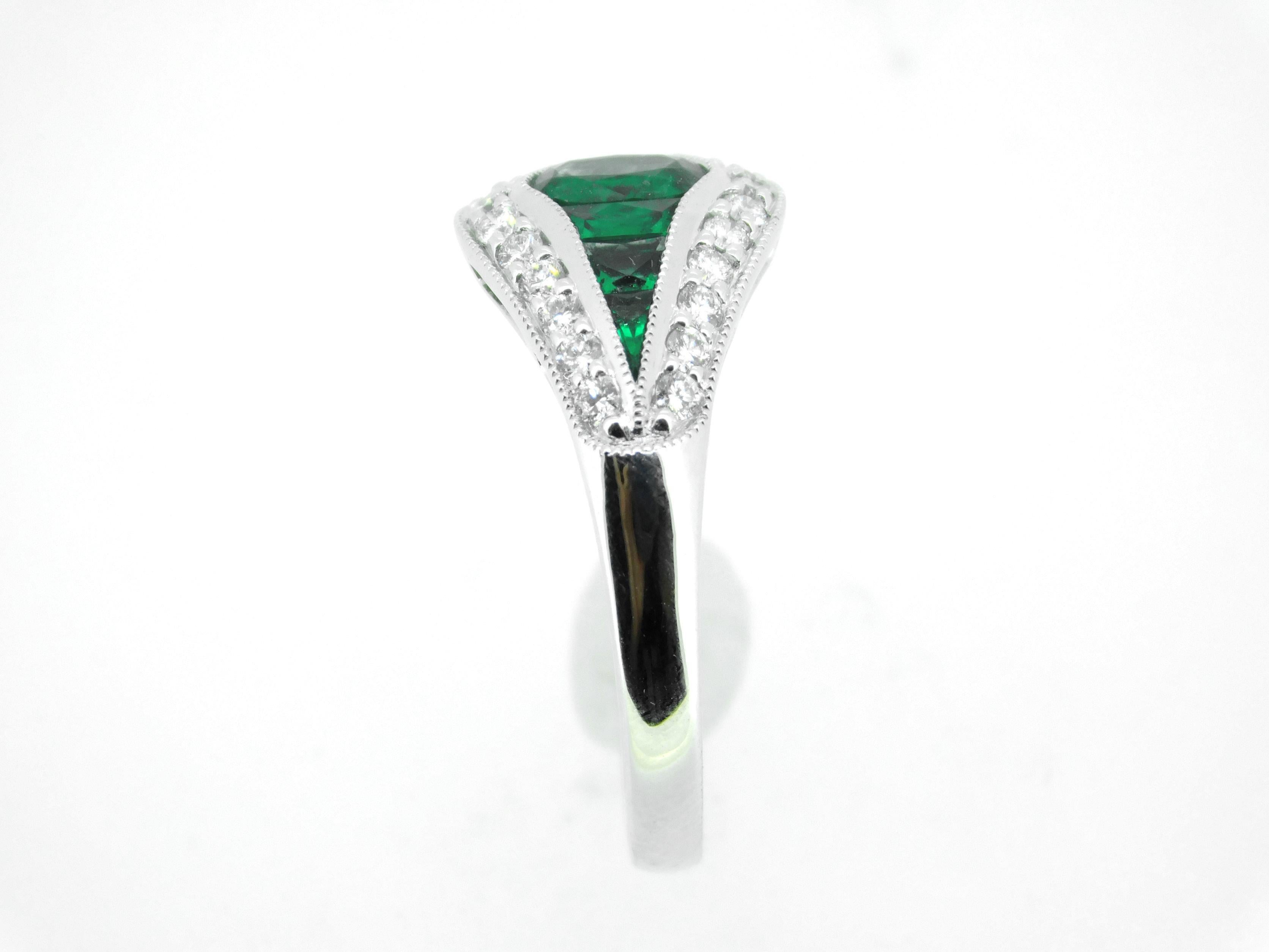 18k Gold Specialty Cut Fine Genuine Natural Emerald and Diamond Ring (#J5124)

18k white gold emerald and diamond ring featuring seven earth mined emeralds weighing 1.04 carats total. The center oval emerald weighs .40cts, and the six side specialty