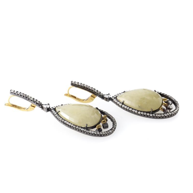 Refreshingly original and unlike any other, this pair of earrings are sure to please! The earrings are made of a combination of diamond-lined 18K yellow gold and stainless steel and are set with faceted yellow sapphires.

