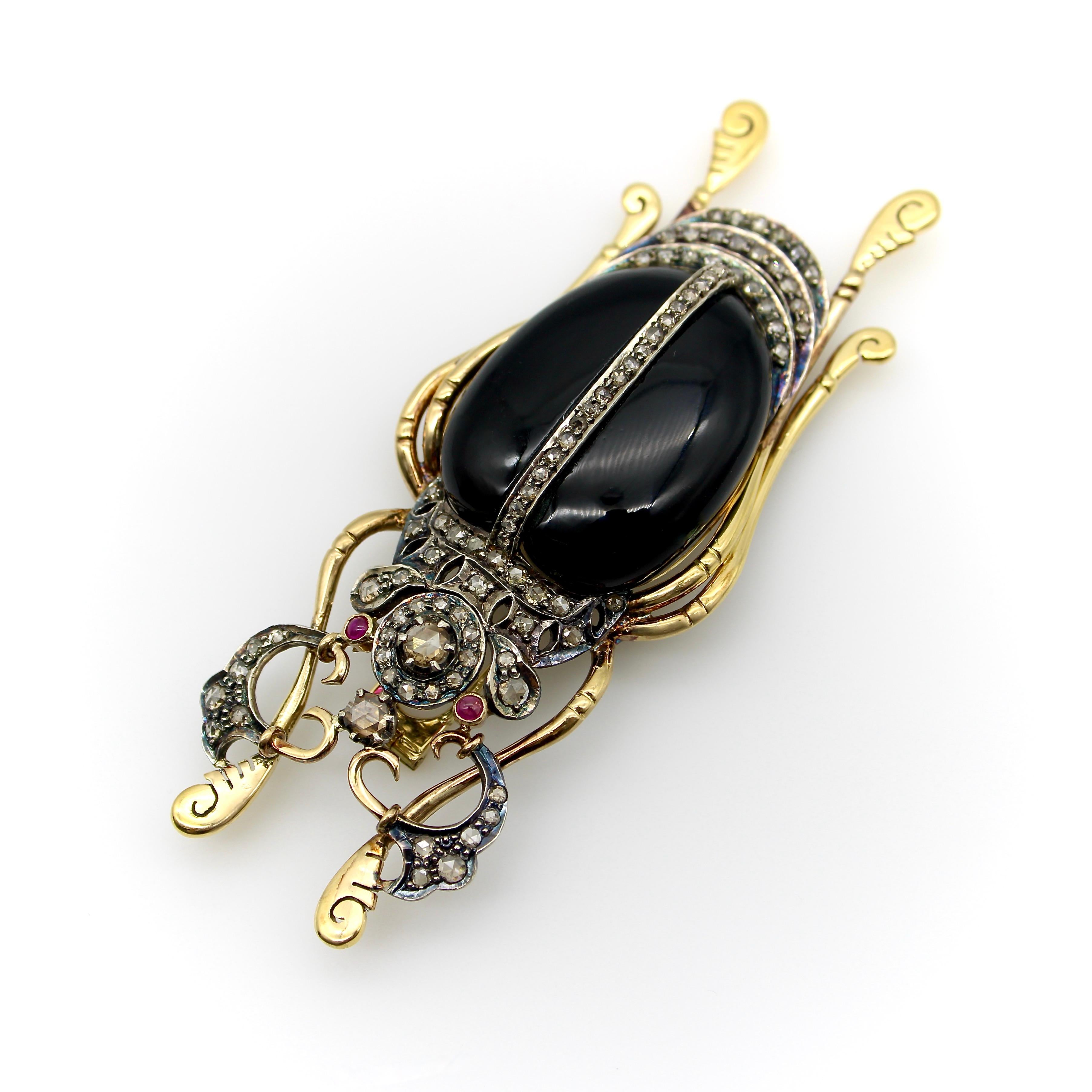Circa the Edwardian era, this large and impressive Rhinoceros beetle brooch is encrusted with Rose Cut diamonds on an 18k gold and sterling silver body. The insect’s head and antenna are accentuated with patterns of  diamonds in stylized floral