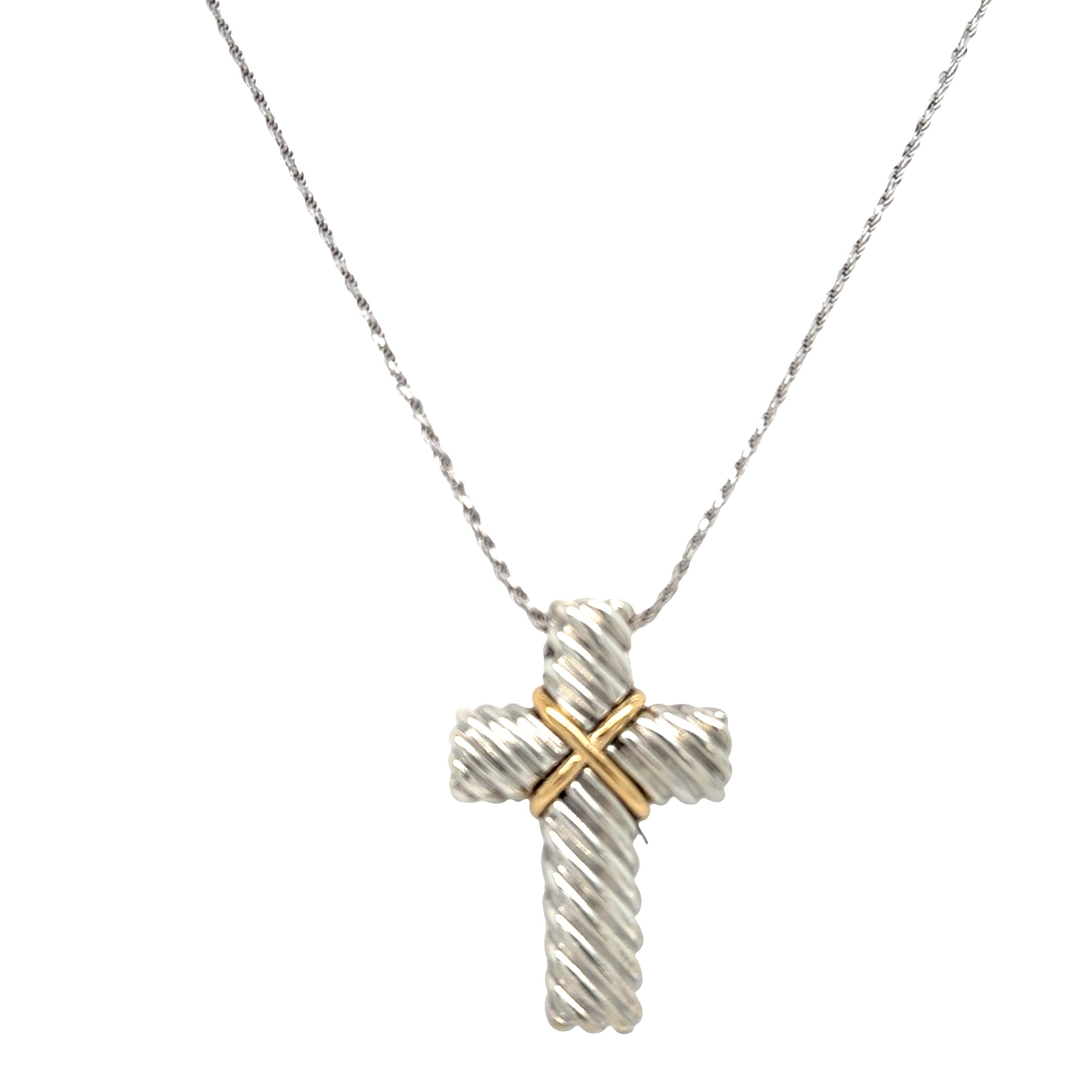 This exquisite cross necklace combines 18k yellow gold and sterling silver with a unique rope groove design finished in a brilliant shine. Measuring 22 inches long and weighing 15.3 grams, it features a 1 x 1.5 inch cross pendant where yellow gold