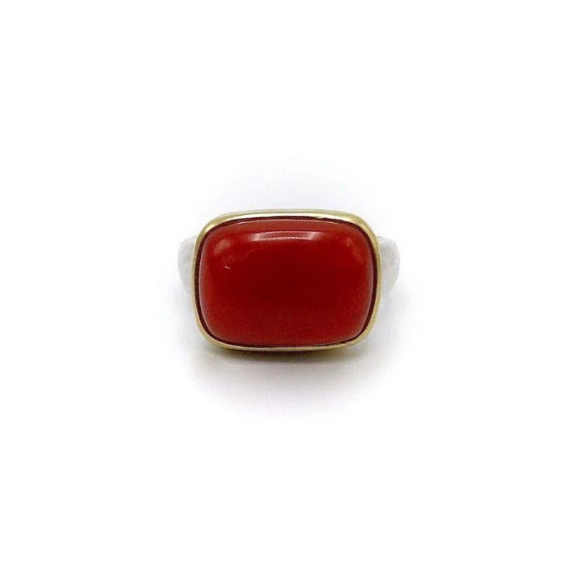 This is a beautiful 18k gold and sterling silver ring featuring a deep red Sardinian coral cabochon by the Santa Fe jewelry designer Tony Malmed.

The coral is bezel set in 18k yellow gold and the back is made with sterling silver. The band is also
