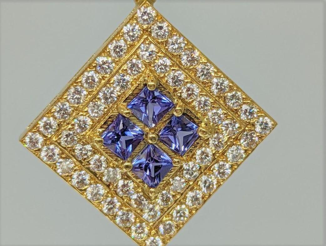 Sitting in an 18K yellow gold frame, with two rows of Diamonds (1.53cts) are 4 square cut Tanzanites that weigh 1.03cts.  Because of the play of purple throughout the stone, Tanzanites are extremely difficult to match, but these match very well. 