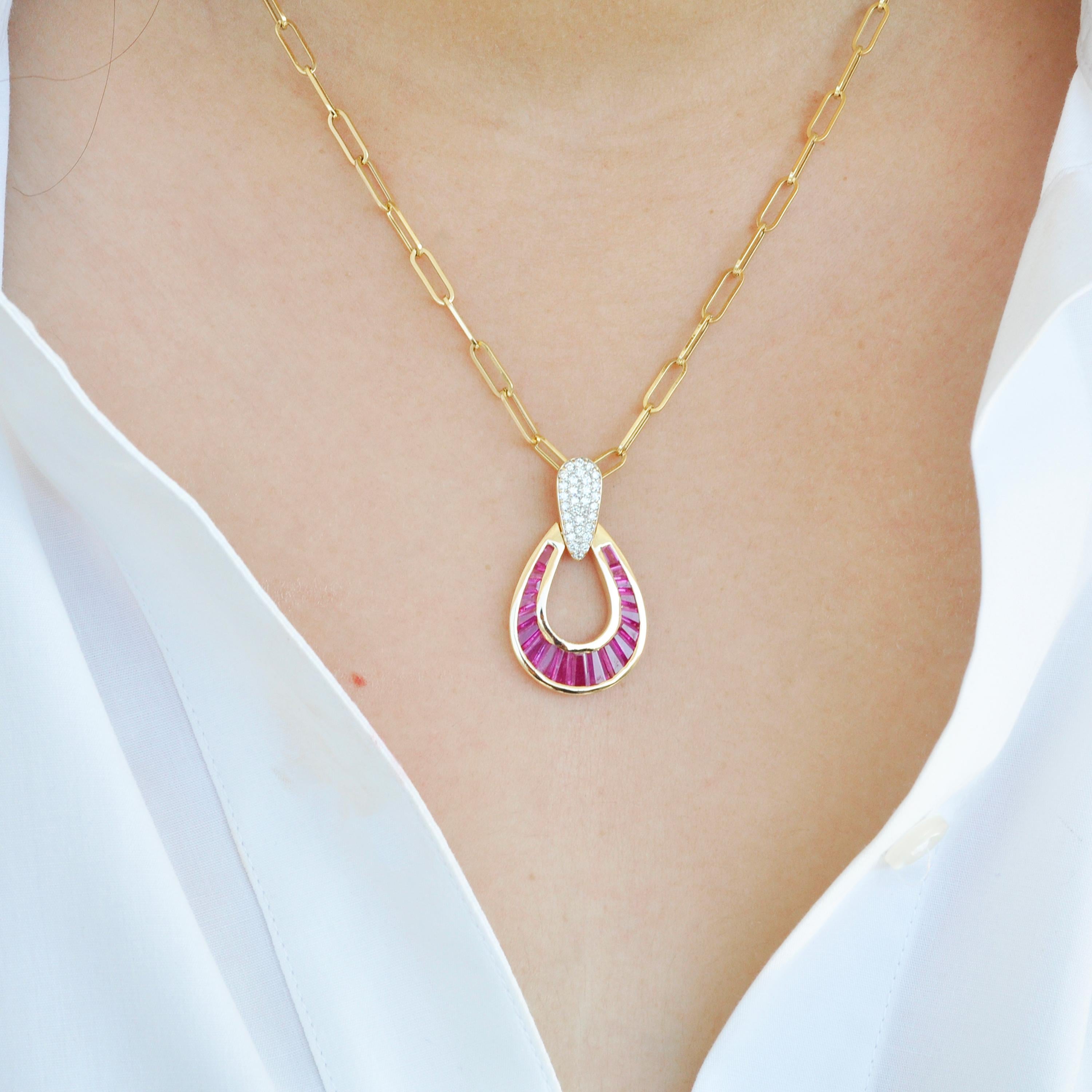 Taper baguette calibre cut ruby 18k gold diamond tear-drop pendant necklace.

This extraordinary raindrop crimson red ruby pendant is encapsulating. Meticulous hand-picked selections of lustrous ruby gemstones out of many are set individually