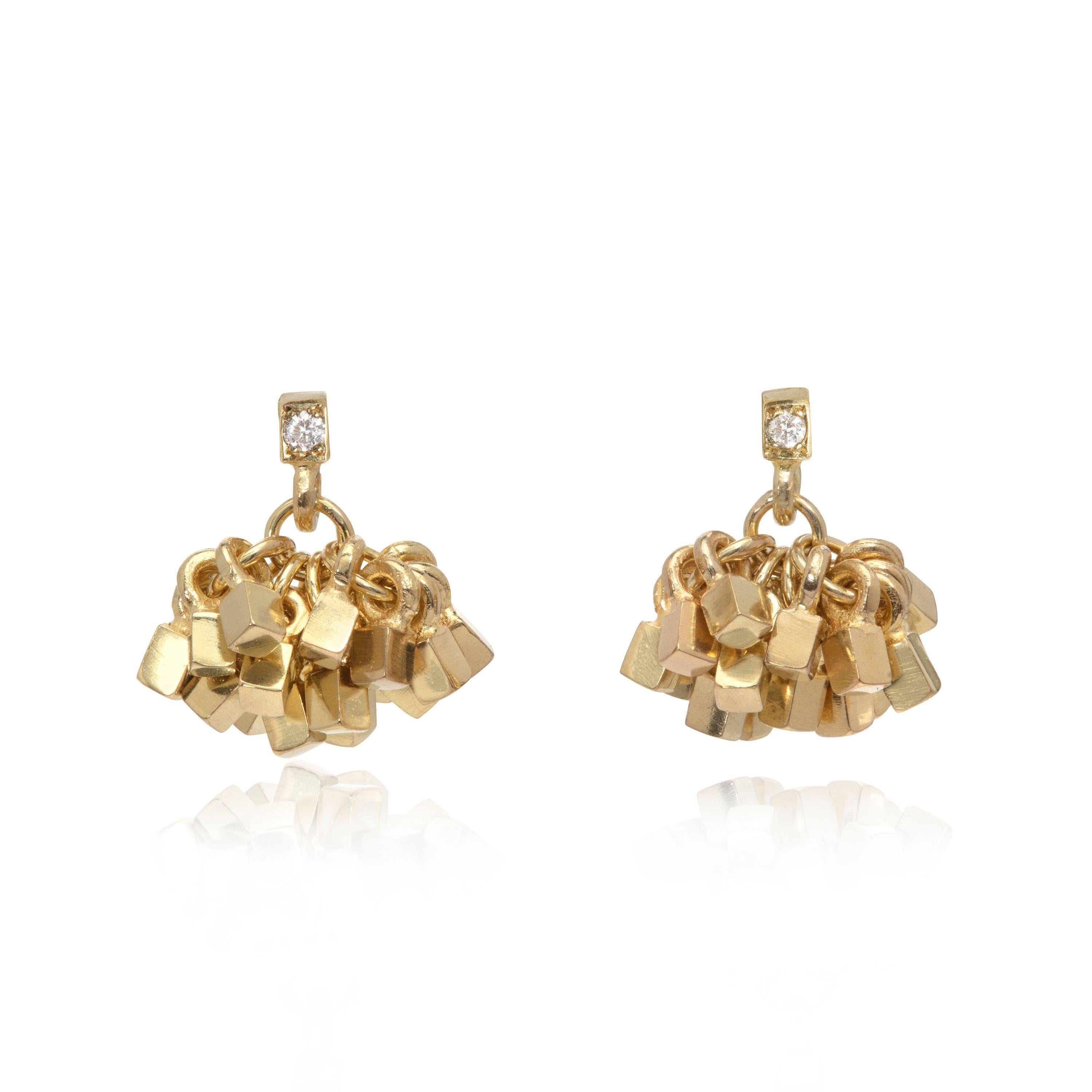 These elegant, striking earrings in 18K gold are designed and made by UK jeweler Sarah Pulvertaft. Beneath the diamond accented square top is a 