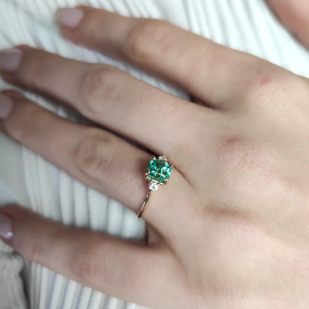 Immerse yourself in elegance with our 18K Gold Three-Stone Emerald and Diamond Ring, meticulously crafted for daily wear. Featuring a central emerald and diamonds, it redefines sophistication with enduring allure. Elevate your style with this