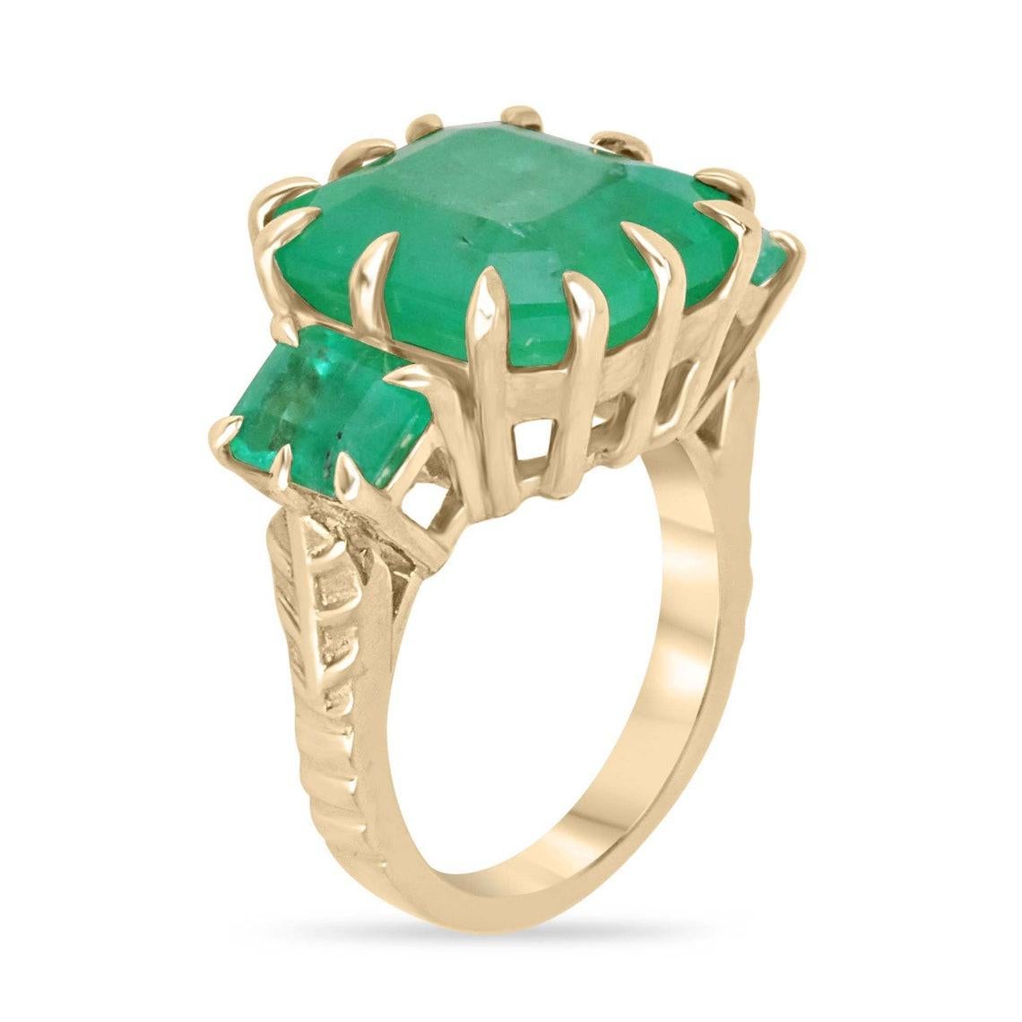 Immerse yourself in the allure of our Emerald Three-Stone Trilogy Ring, a magnificent masterpiece that epitomizes timeless sophistication. Three emerald-cut emeralds, boasting a vivid medium-green color and translucent clarity, command attention as