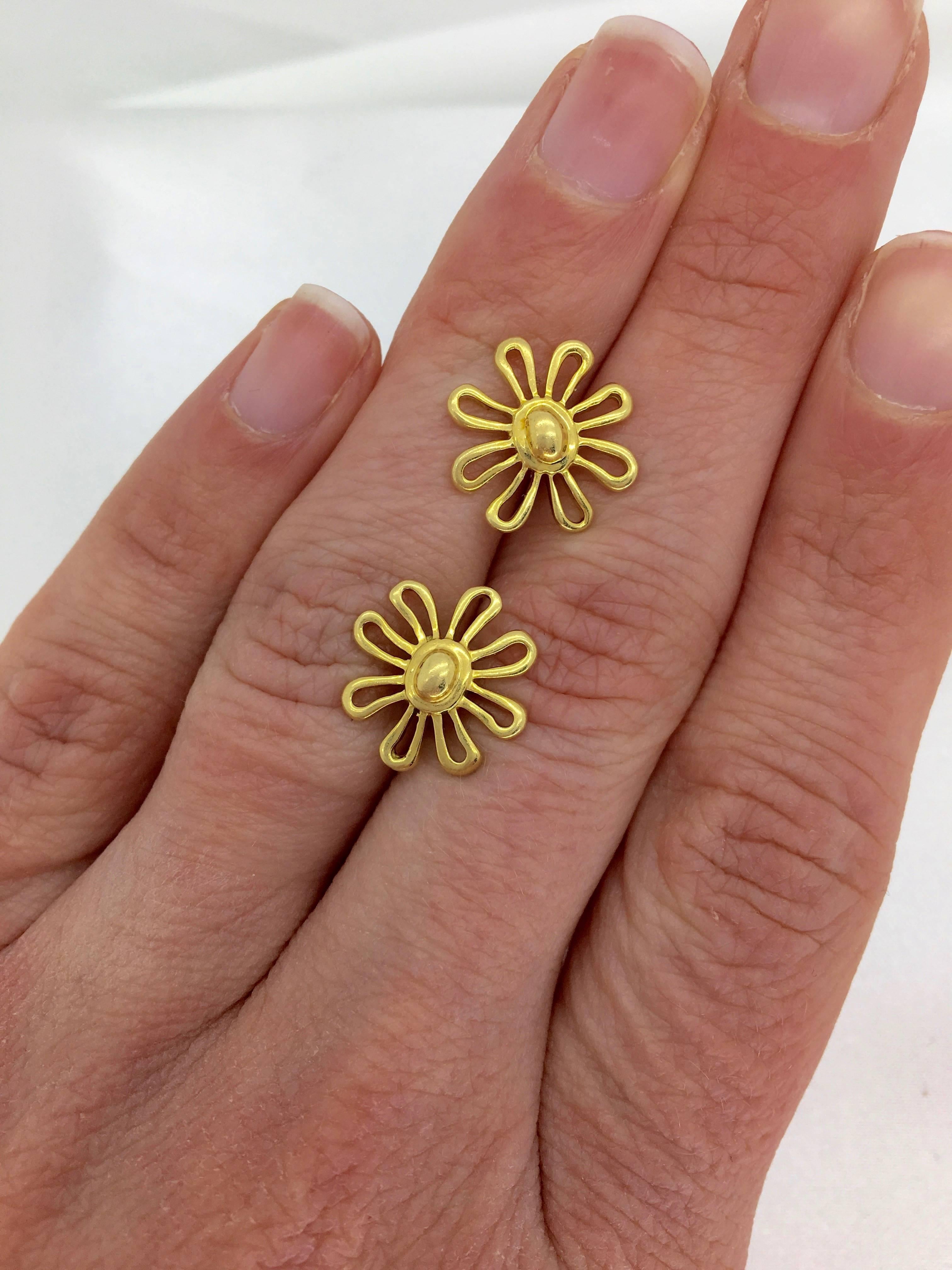 These 18K Yellow Gold Tiffany & Co. Paloma Picasso Daisy earrings measure approximately  .5” in diameter and weigh 4.6 grams. The earring posts and backs are stamped “T & CO 750”, and the backs of the earrings are stamped “Picasso”.  
